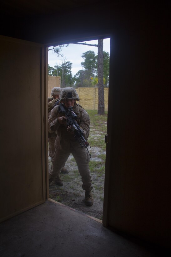 Marines of Company K, Battalion Landing Team (BLT) 3/2, currently reinforcing the 26th Marine Expeditionary Unit (MEU), kick in a door during the mechanized raid course at Camp Lejeune, N.C., Oct. 10, 2012. BLT 3/2 is one of the three reinforcements of 26th MEU, which is slated to deploy in 2013.