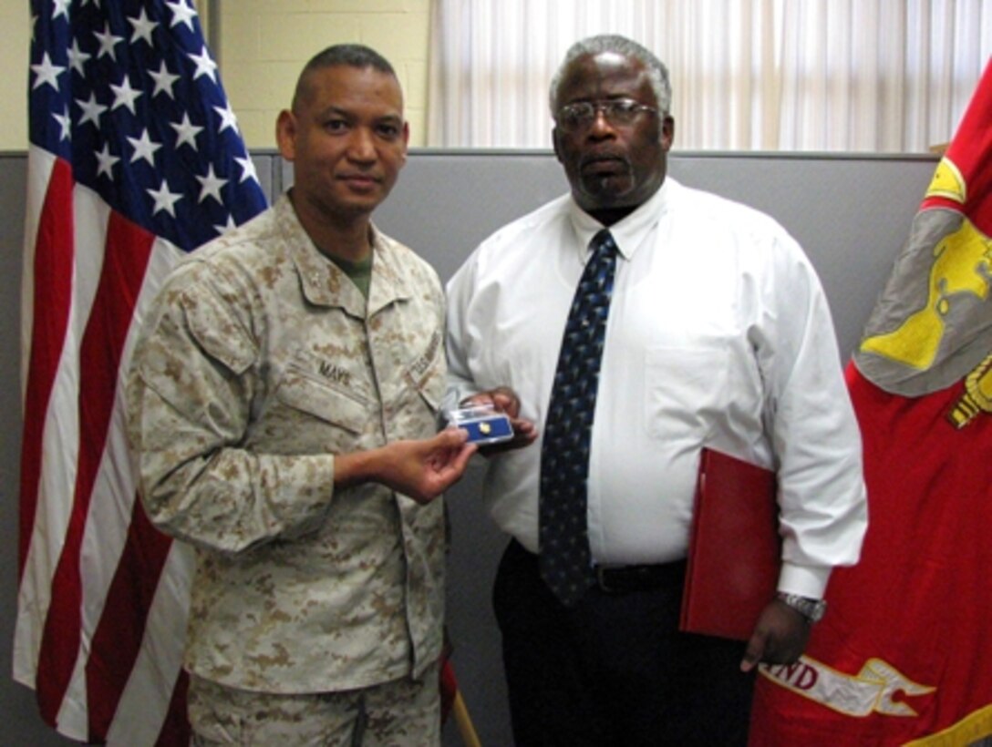 Colonel Ed Mays, Marine Corps Systems Command’s (MCSC) Assistant Commander for Acquisition Logistics and Product Support, presents James Harvey, an employee with the MCSC detachment in Albany, Ga., his 40-Year Federal Service pin. , MCSC Albany, 9/30/2012 10:11 AM