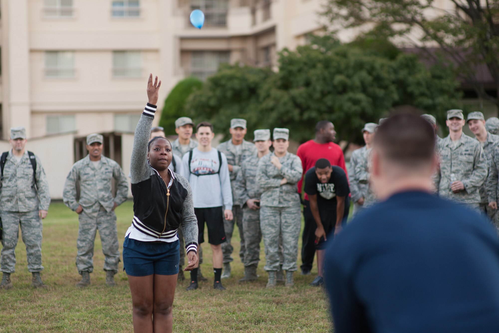 YOKOTA AIR BASE, Japan -- Airman 1st Class Nicole Orr, right, 374th Maintenance Squadron, catches a water balloon from her partner during the Combine Federal Campaign - Overseas balloon toss competition at Yokota Air Base, Japan, Oct. 19, 2012. Teams participated in a variety of events during a burger burn to raise money for the CFC. (U.S. Air Force photo by Osakabe Yasuo) 