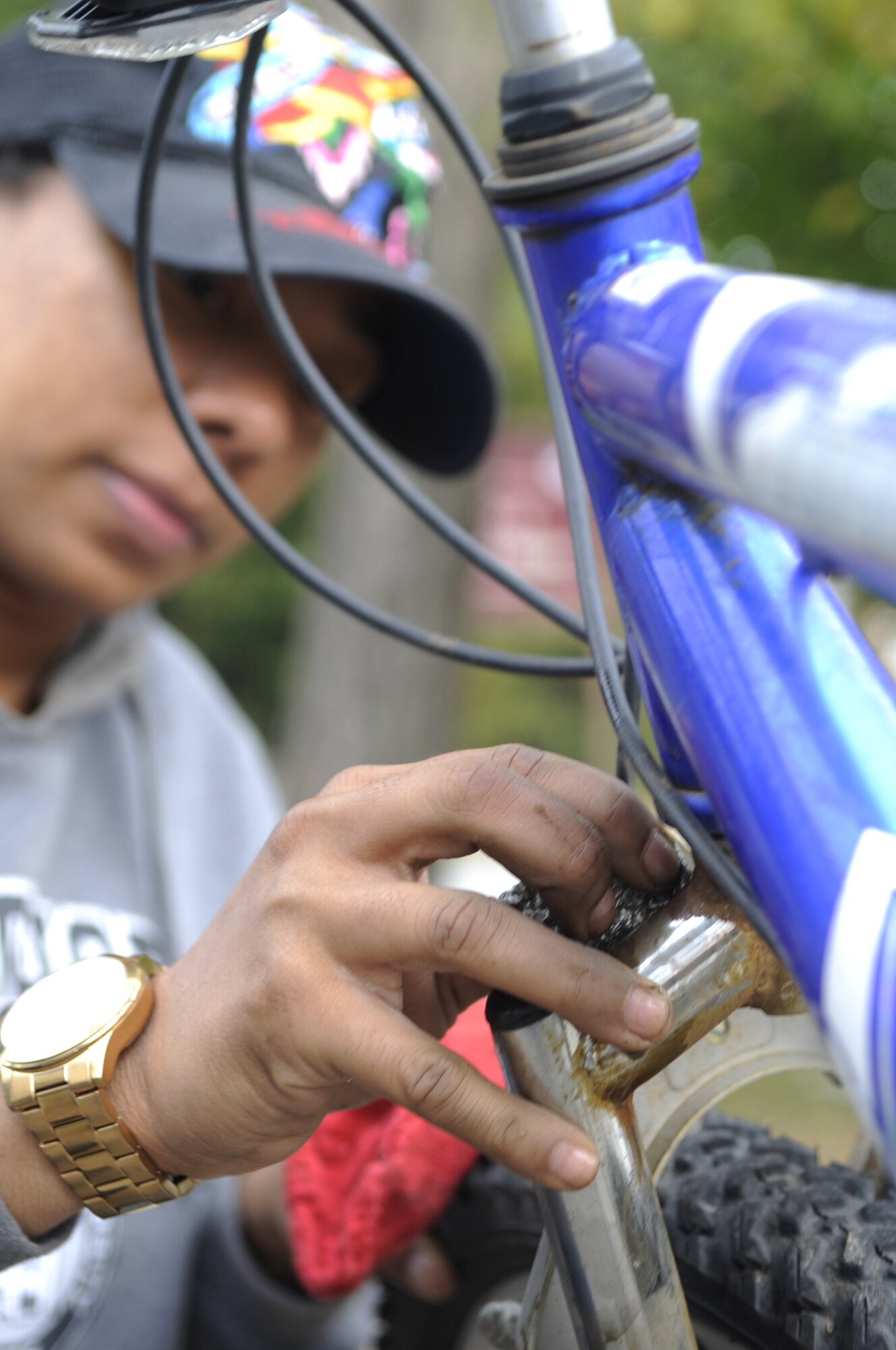 Airman 1st Class Raven Carter, 80th Fighter Squadron, removes rust from a repossessed bicycle during Operation Kunsan Rides Oct. 20, 2012, at Kunsan Air Base, Republic of Korea. Carter was one of more than 15 Airmen Committed to Excellence who showed up to help with the service project and give back to the local community. (U.S. Air Force photo/Senior Airman Brigitte N. Brantley)