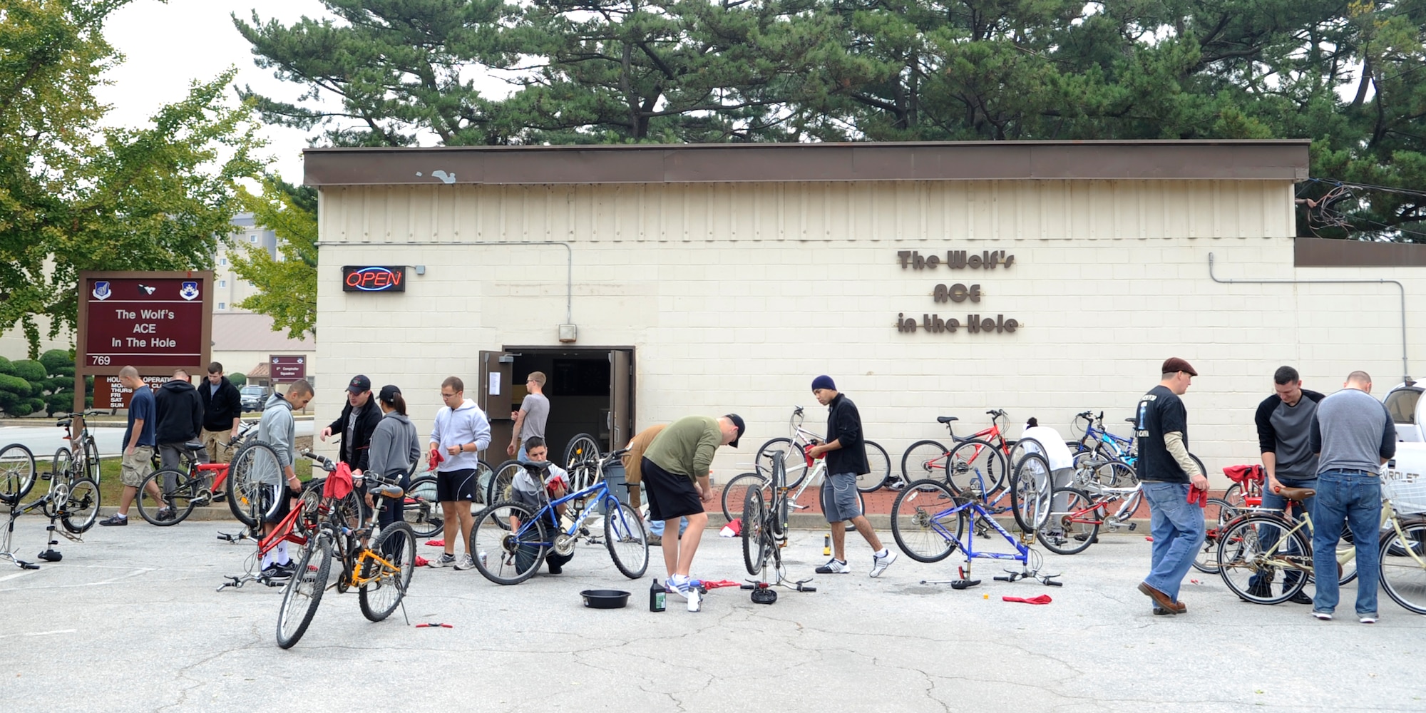 Airmen Committed to Excellence members work together to fix bicycles to donate to charity Oct. 20, 2012, at Kunsan Air Base, Republic of Korea, as a part of Operation Kunsan Rides. This is the first of many ACE service projects which will give back to the local community. (U.S. Air Force photo/Senior Airman Brigitte N. Brantley)