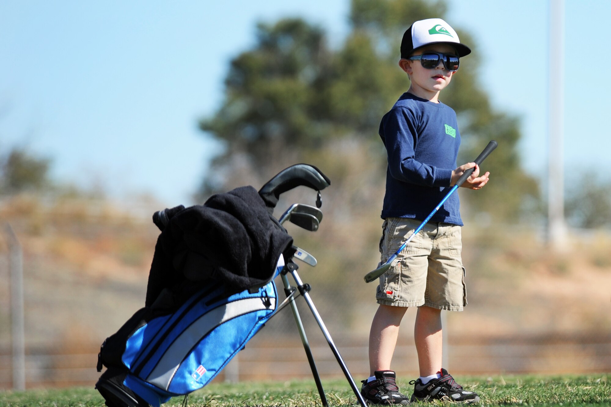 Gavin, son of U.S. Air Force Staff Sgt. Dustin Anderson, 27th Special Operations Logistics Readiness Squadron, prepares his club during a golf clinic at Cannon Air Force Base, N.M., Oct. 20, 2012.  Two PGA Class A golfers from Texas Tech University gave free instruction to Cannon Airmen and their families as a way of giving back to the military.