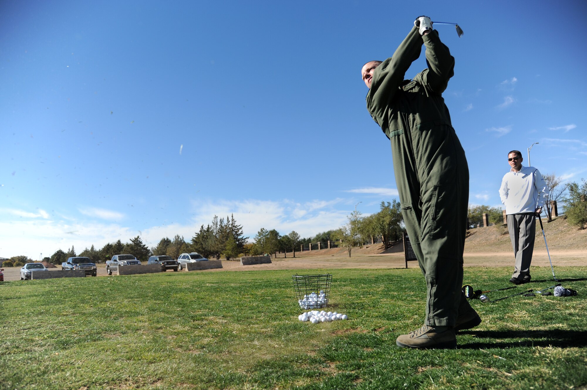 U.S. Air Force Master Sgt. Aaron Barber, 3rd Special Operations Squadron, hits a ball during a golf clinic at Cannon Air Force Base, N.M., Oct. 20, 2012.  Two PGA Class A golfers from Texas Tech University gave free instruction to Cannon Airmen and their families as a way of giving back to the military. (U.S. Air Force photo/Senior Airman Jette Carr)