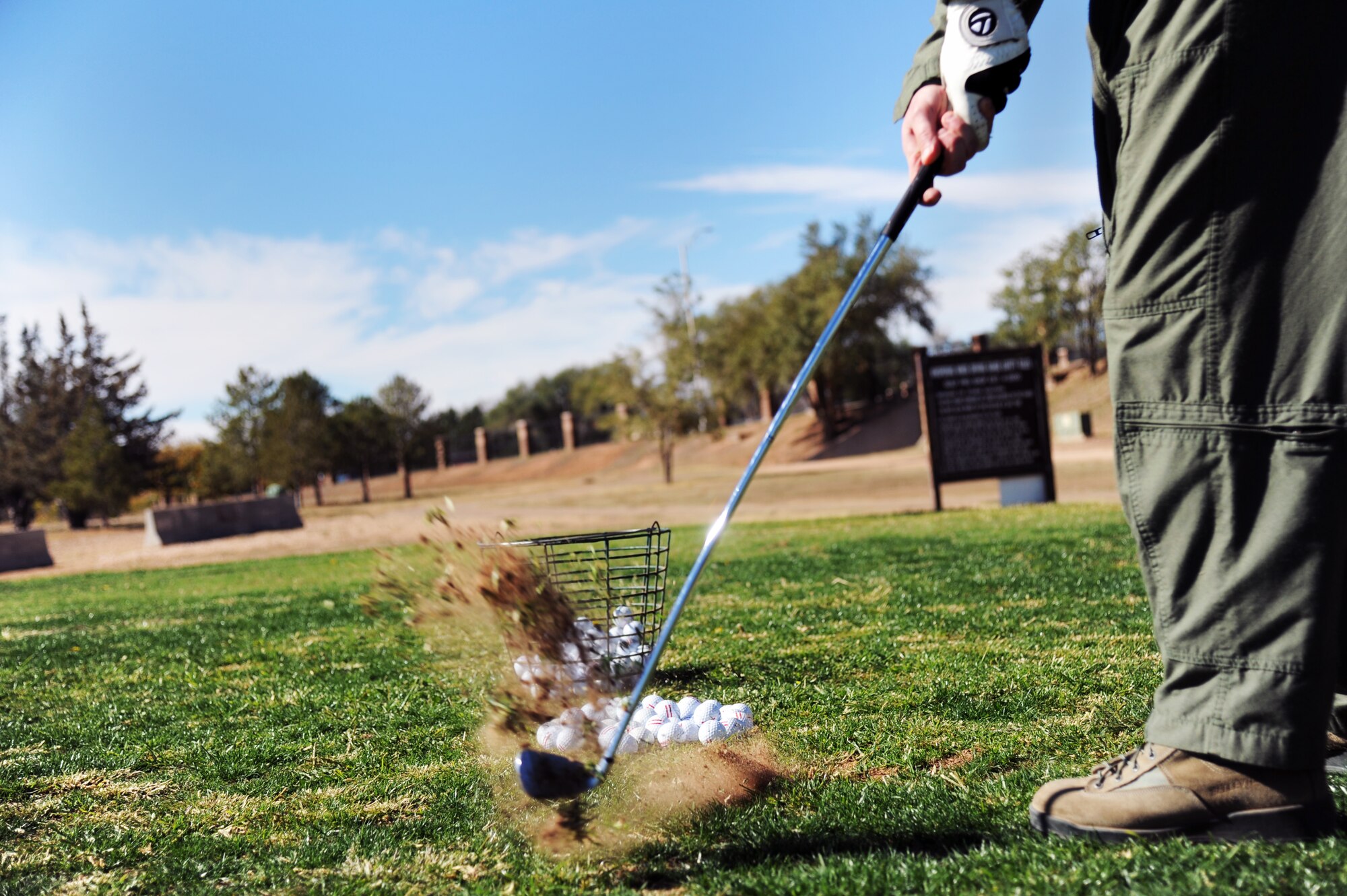 U.S. Air Force Master Sgt. Aaron Barber, 3rd Special Operations Squadron, hits a ball during a golf clinic at Cannon Air Force Base, N.M., Oct. 20, 2012.  Two PGA Class A golfers from Texas Tech University gave free instruction to Cannon Airmen and their families as a way of giving back to the military. (U.S. Air Force photo/Senior Airman Jette Carr)