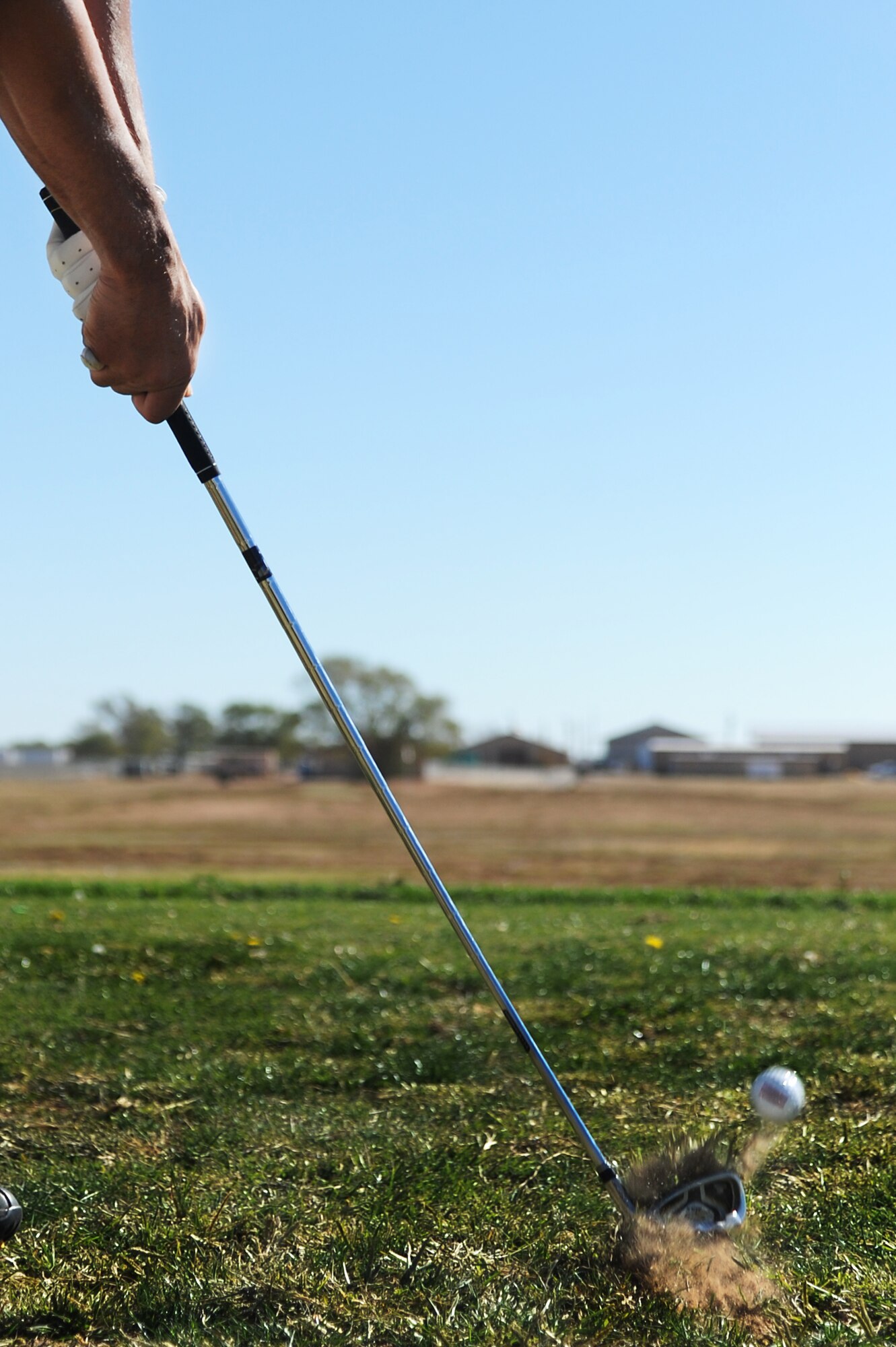 U.S. Air Force Staff Sgt. David Showers, 27th Special Operations Support Squadron, hits a ball during a golf clinic at Cannon Air Force Base, N.M., Oct. 20, 2012.  Two PGA Class A golfers from Texas Tech University gave free instruction to Cannon Airmen and their families as a way of giving back to the military. (U.S. Air Force photo/Senior Airman Jette Carr)