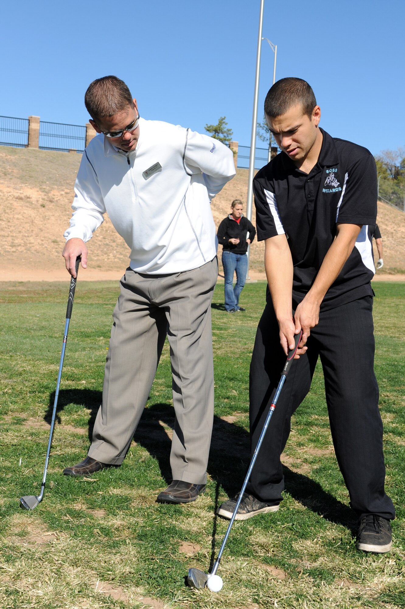 Robert Kearney, head golf professional at Texas Tech University, teaches U.S. Air Force Airman 1st Class Rody Garcia, 27th Special Operations Support Squadron, during a golf clinic at Cannon Air Force Base, N.M., Oct. 20, 2012.  Two PGA Class A golfers from Texas Tech University gave free instruction to Cannon Airmen and their families as a way of giving back to the military.  (U.S. Air Force photo/Senior Airman Jette Carr)