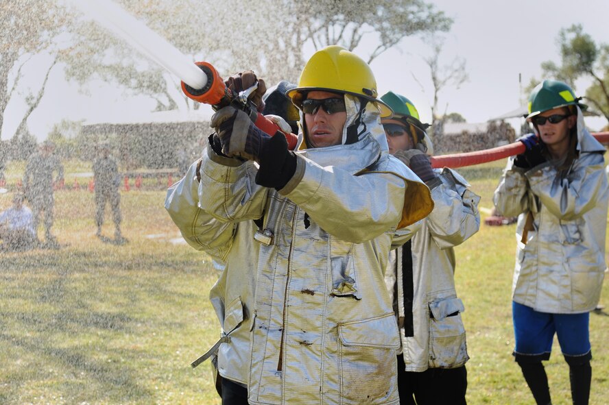 Competitors hit their target with a fire hose during the 14th Annual Fire Muster at Cannon Air Force Base, N.M., Oct. 19, 2012.  This friendly competition serves as a way for squadrons to build teams and foster comradery around base.  (U.S. Air Force photo/Senior Airman Jette Carr)