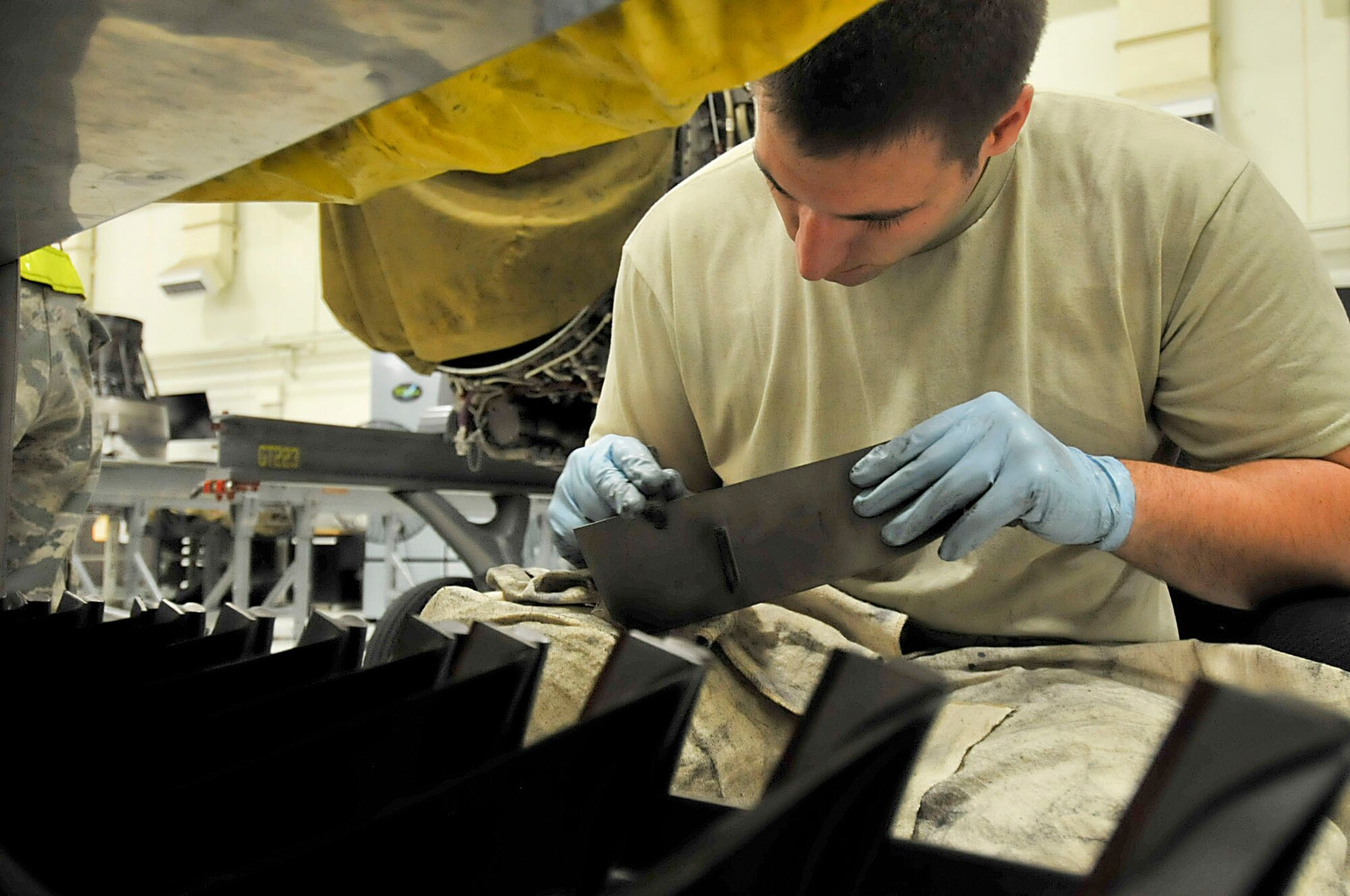 U.S. Air Force Senior Airman Cody Hammond, 18th Component Maintenance Squadron aerospace propulsion journeyman, inspects and cleans F-15 Eagle fan blades during the second day of a Pacific Air Forces readiness inspection on Kadena Air Base, Japan, Oct. 23, 2012. Inspecting the blades before putting them back in ensures that it won't fall apart inside the F-15 Eagle engine. The readiness inspection tests the 18th Wing on its ability to survive and operate in a contingency. (U.S. Air Force photo/Staff Sgt. Darnell T. Cannady)