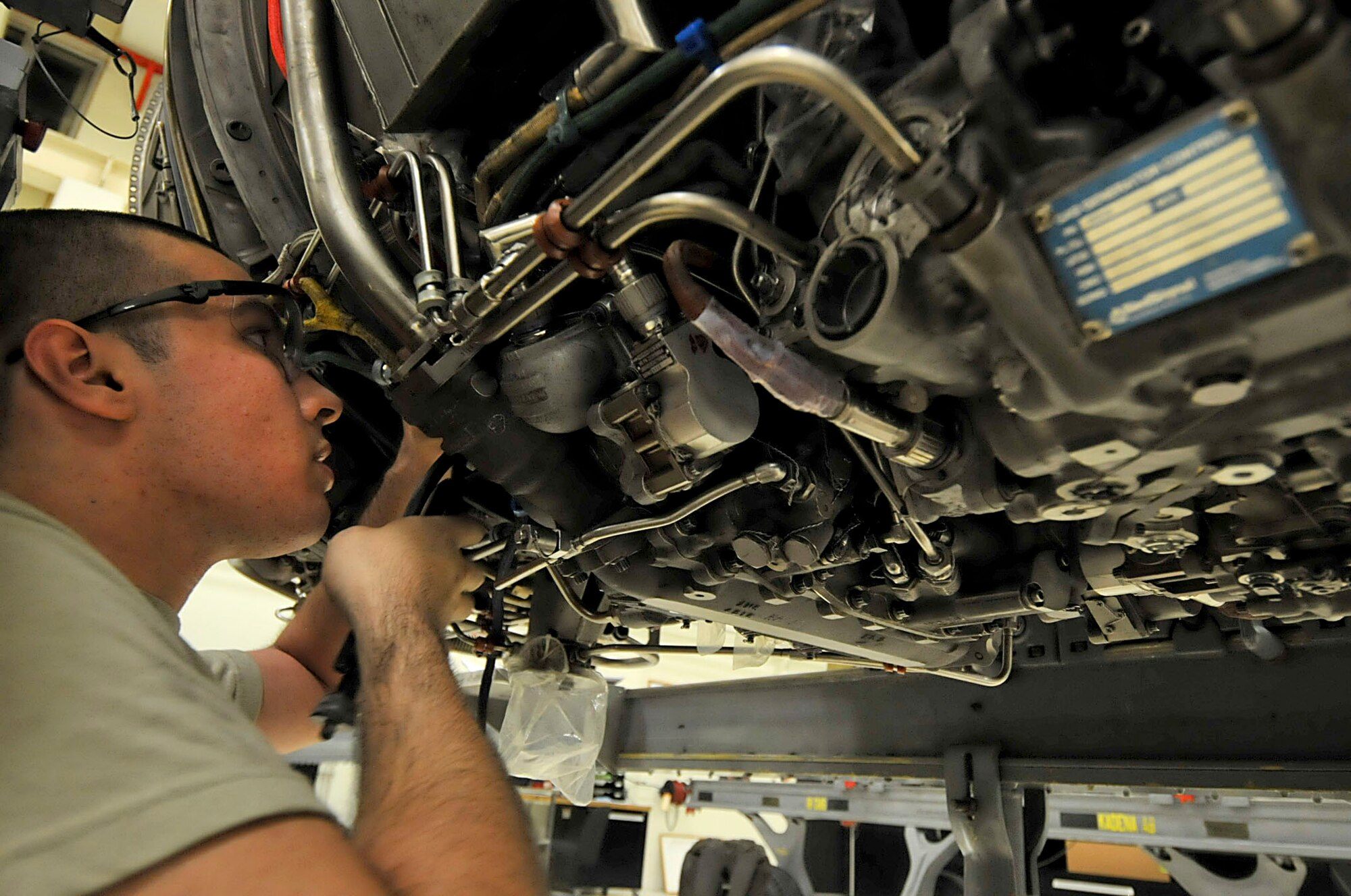 U.S. Air Force Airman 1st Class Kyle Weyant, 18th Component Maintenance Squadron aerospace propulsion apprentice, works on an F-15 Eagle engine during the second day of a Pacific Air Forces readiness inspection on Kadena Air Base, Japan, Oct. 23, 2012. He is tying down probes to ensure that they do not move around inside the F-15 Eagle during flight. This inspection tests the 18th Wing on its ability to survive and operate in a contingency. (U.S. Air Force photo/Staff Sgt. Darnell T. Cannady)