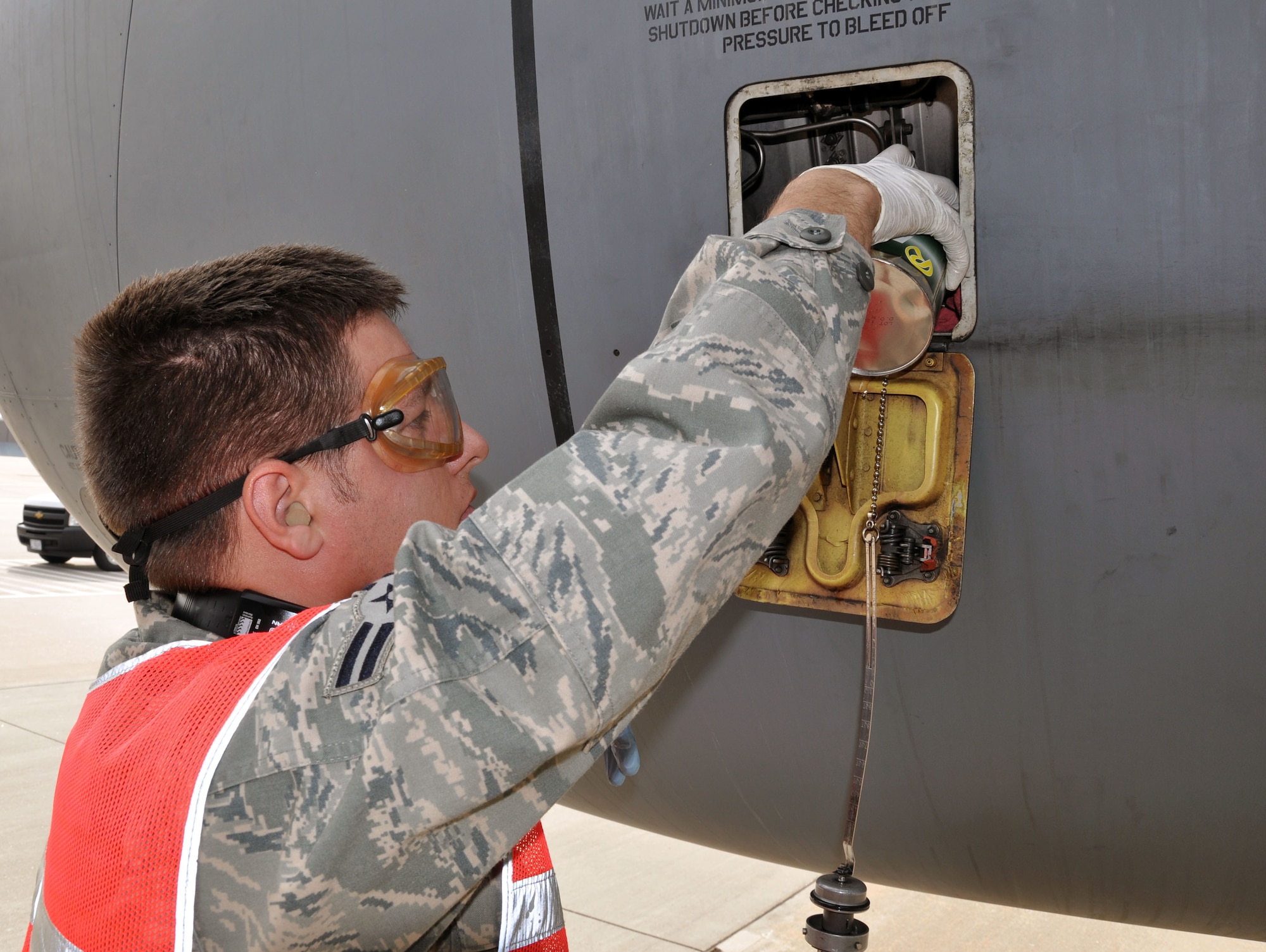 Airman 1st Class Patrick Monroe, a crew chief assigned to the Air Force Reserve 931st Aircraft Maintenance Squadron adds oil to one of the engines of a KC-135 Stratotanker on the flight line at McConnell Air Force Base, Kan., Oct. 22, 2012.  The aircraft had just returned from an overseas flight.  Along with numerous other tasks, maintainers check the oil in each of the four engines on the Stratotankers after every flight and service the oil levels whenever necessary.  The KC-135 provides the core aerial refueling capability for the U.S. Air Force, and has been performing in this role for more than 50 years. (U.S. Air Force photo by 1st Lt. Zach Anderson) 