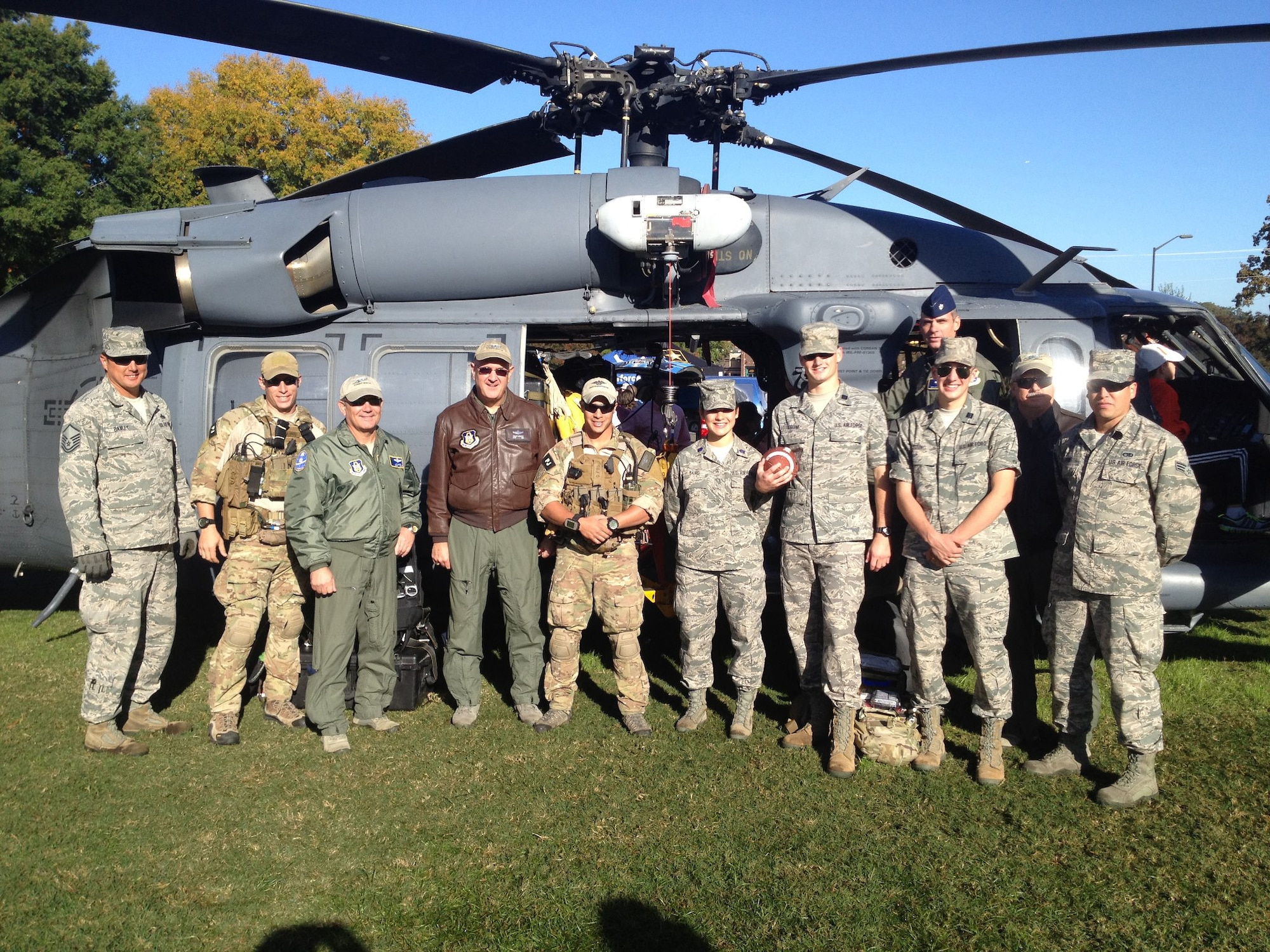 Combat search and rescue Airmen from the 920th Rescue Wing, Patrick Air Force Base, Fla., piloted an HH-60G Pave Hawk helicopter to South Carolina parking it next to Frank Howard Field at Memorial Stadium Clemson, S.C. October 20 for a Military Appreciation Celebration game against Virginia Tech. The Airmen were honored during halftime of Clemson's victorious game. Among them was Pave Hawk pilot Lt. Col. Phillip Kennedy (4th fom the left), 920th Rescue Wing, a Clemson alumni who's sighting of an H-3 helicopter in the same setting years earlier inspired inspired the colonel's present career as combat rescue pilot. (Coutesy photo)
