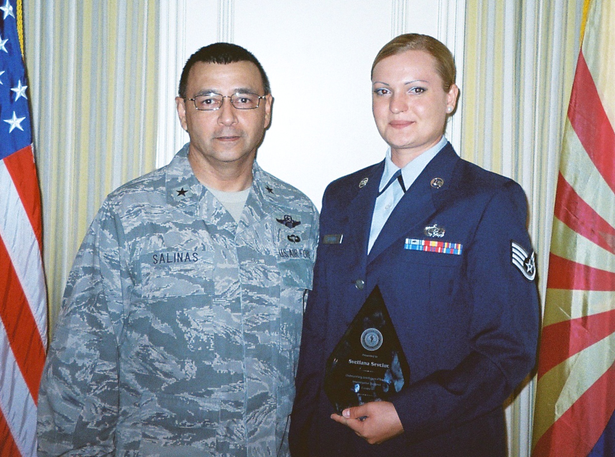 U.S. Air Force Staff Sgt. Svetlana Sevciuc received the Outstanding Analyst of the Year award from the Director Joint Staff of the Air National Guard Brig. Gen. Jose Salinas. Sgt. Sevciuc of the 162nd Fighter Wing Services Squadron uses her skills as an intelligence analyst to support the Arizona Joint Counter Narcotic-Terrorism Task Force mission. (U.S. Air Force photo/Released)