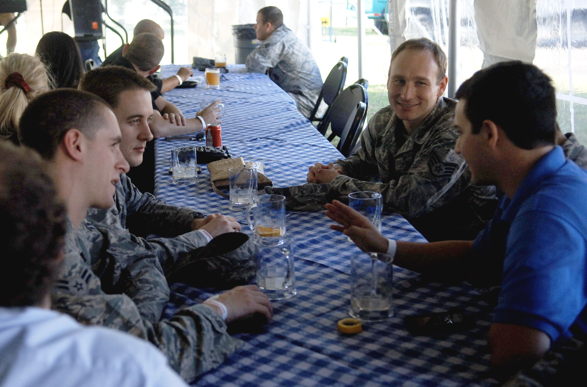 Air Force Staff Sgt. Justin Scherer (center right), 633rd Air Base Wing Contracting Squadron contracting specialist, socializes with his coworkers Oct. 19 during Boss & Buddy Oktoberfest at the Langley Air Force Base Club.  Scherer said he really enjoyed the polka music from the band, The Happy Dutchmen.  (U.S. Air Force photo by Staff Sgt. Katie G. Ward / Released)