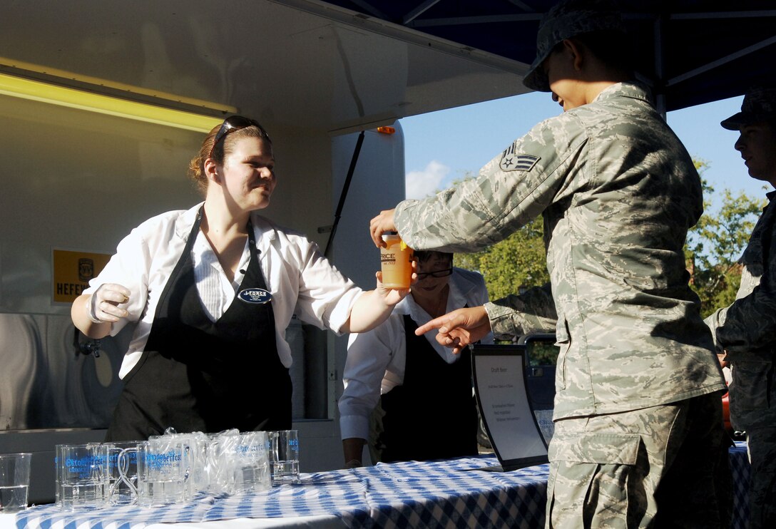 Leah Coats, a banquet server for the Langley Air Force Base Club, hosts the beer tent Oct. 19 during Boss & Buddy Oktoberfest at the Langley Air Force Base Club.  This is the first year the club has hosted an Oktoberfest event.  (U.S. Air Force photo by Staff Sgt. Katie G. Ward / Released)