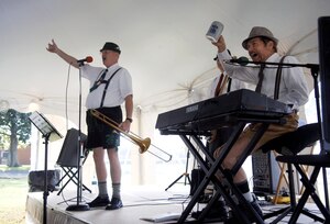 From left, Russ Robertson, Glen Boswick and Marc Marique, members of The Happy Dutchmen, engage the audience in a German polka song Oct. 19 during Boss & Buddy Oktoberfest at the Langley Air Force Base Club.  The Happy Dutchmen are based in the Tidewater area and have been touring together for 10 years.  (U.S. Air Force photo by Staff Sgt. Katie G. Ward / Released)