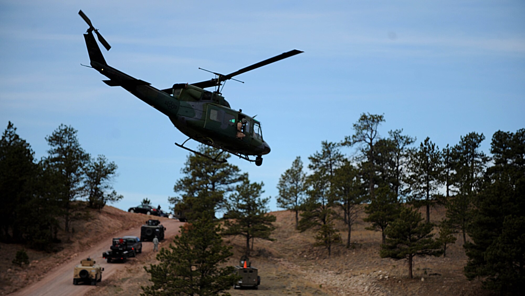A UH-1N Huey helicopter takes off during the Road Warrior exercise at Camp Guernsey, Wyo., Oct. 19, 2012. The helicopters used during the exercise provide a bird's-eye view of the nuclear resource convoy, while scanning for potential threats. (U.S. Air Force photo by Senior Airman Jarad A. Denton/Released)
