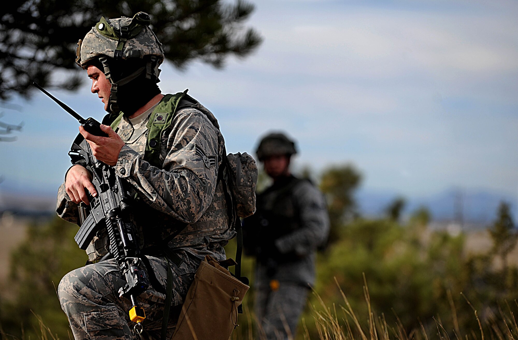 A Security Forces Airman from F.E. Warren Air Force Base, Wyo., radios his position and status during the Road Warrior Exercise at Camp Guernsey, Wyo., Oct. 19, 2012. During Road Warrior, airmen are taught that communication plays a vital role in any tactical operation. (U.S. Air Force photo by Senior Airman Jarad A. Denton/Released)
