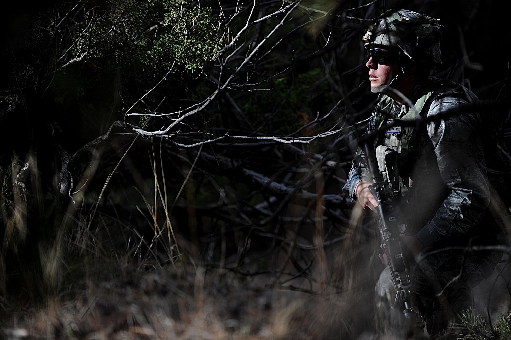 A Security Forces Airman from F.E. Warren Air Force Base, Wyo., pauses while searching for opposing forces during the Road Warrior Exercise at Camp Guernsey, Wyo., Oct. 19, 2012. Airmen are taught to stop, look and listen while searching for possible threats. (U.S. Air Force photo by Senior Airman Jarad A. Denton/Released)
