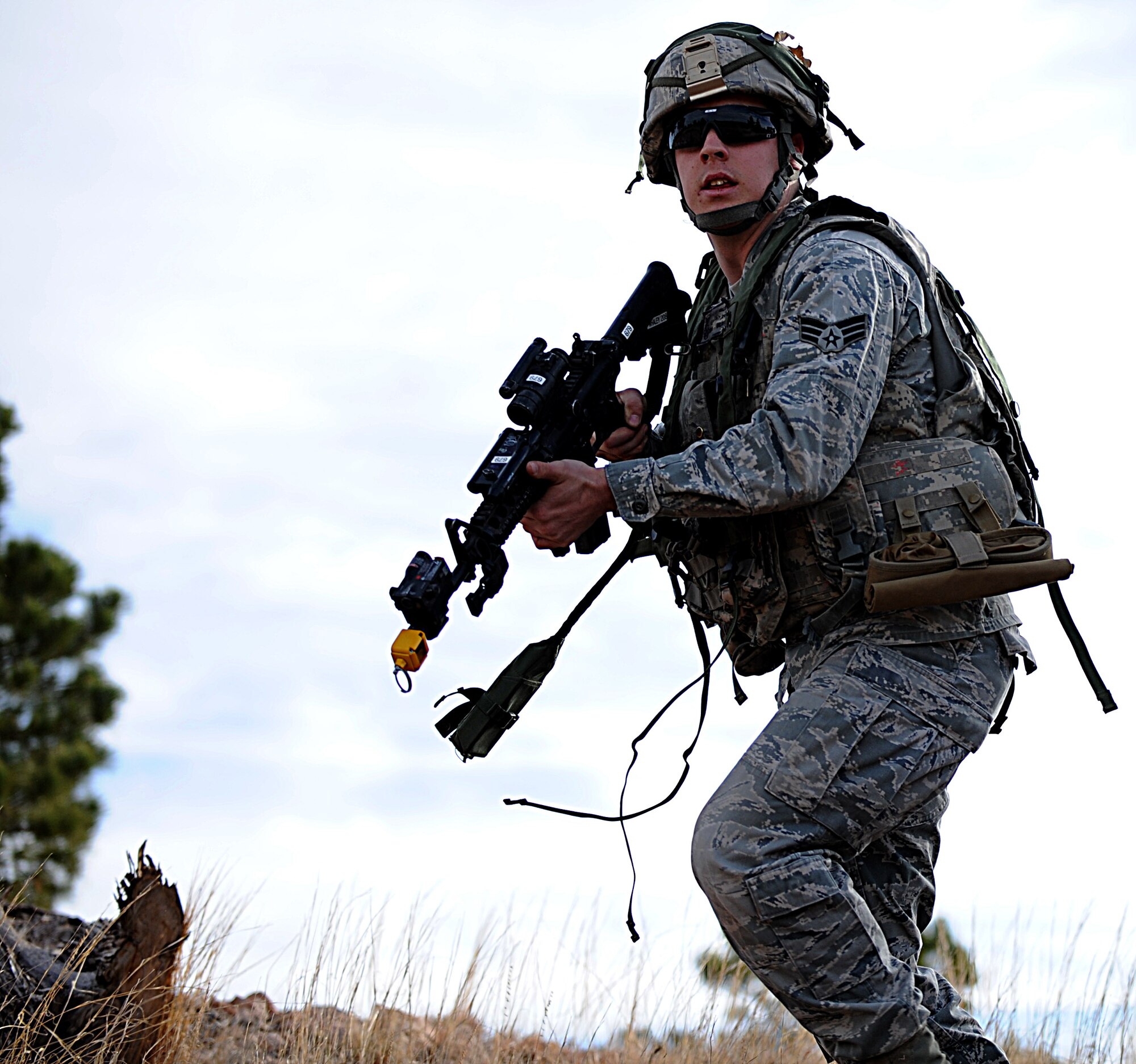 A Security Forces Airman from F.E. Warren Air Force Base, Wyo., scan the terrain for opposing force threats during the Road Warrior Exercise at Camp Guernsey, Wyo., Oct. 19, 2012. The airmen are taught to tactically move over rough and uneven terrain. (U.S. Air Force photo by Senior Airman Jarad A. Denton/Released)
