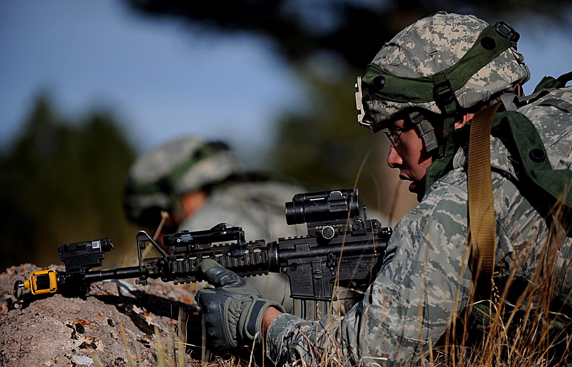 Security Forces Airmen from F.E. Warren Air Force Base, Wyo., scan the terrain for opposing force threats during the Road Warrior Exercise at Camp Guernsey, Wyo., Oct. 19, 2012. During Road Warrior, airmen were taught to protect a nuclear resource during a rolling convoy attack. (U.S. Air Force photo by Senior Airman Jarad A. Denton/Released)
