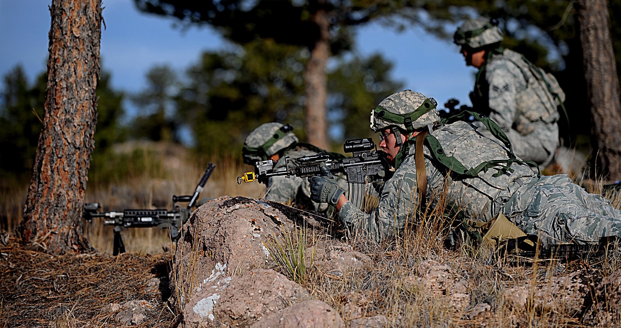 Security Forces Airmen from F.E. Warren Air Force Base, Wyo., scan the terrain for opposing force threats during the Road Warrior Exercise at Camp Guernsey, Wyo., Oct. 19, 2012. Road Warrior is designed to teach Airmen how to safeguard, transport and recover a nuclear resource. (U.S. Air Force photo by Senior Airman Jarad A. Denton/Released)
