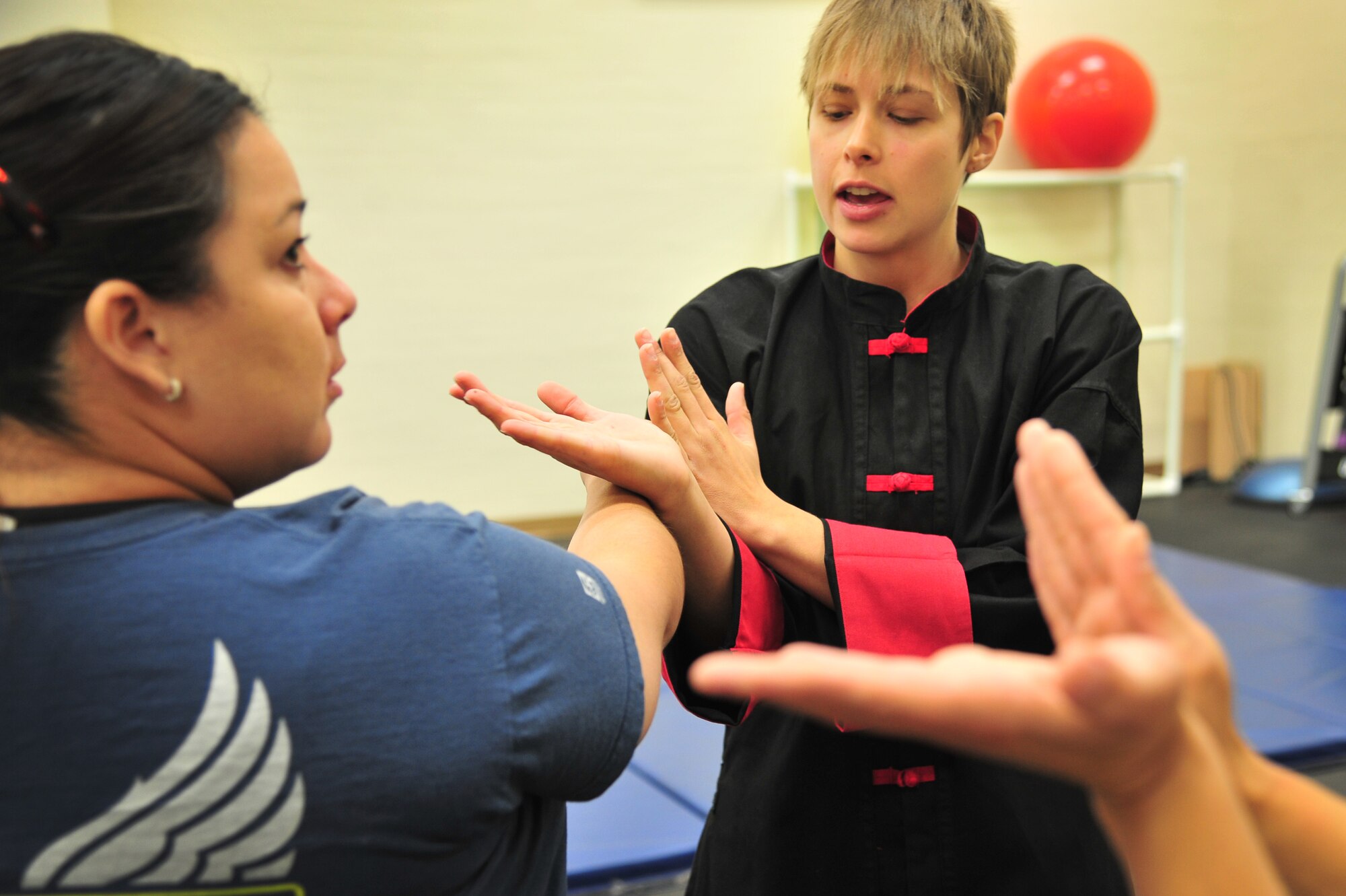 A Jeet Kun Do instructor demonstrates hand maneuvers and blocking to students in the Fitness Center at Cannon Air Force Base, N.M., Oct. 20, 2012. The Sexual Assault Response Coordinator office hosted the free self-defense class in conjunction with Domestic Violence Awareness Month. (U.S. Air Force photo/Airman 1st Class Alexxis Pons Abascal)  