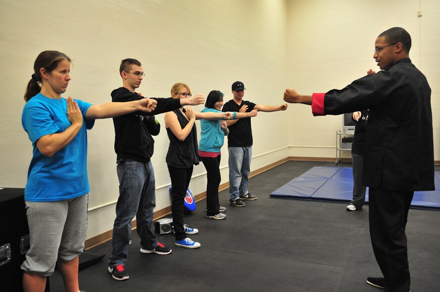 A Jeet Kun Do instructor practices punching technique with students in the Fitness Center at Cannon Air Force Base, N.M., Oct. 20, 2012. The Sexual Assault Response Coordinator office hosted the free self-defense class in conjunction with Domestic Violence Awareness Month. (U.S. Air Force photo/Airman 1st Class Alexxis Pons Abascal)  