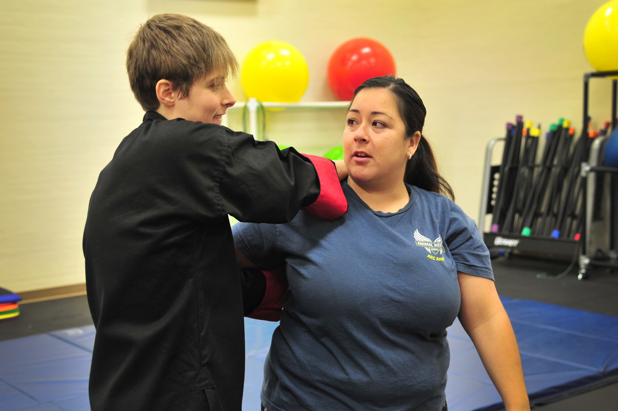 A Jeet Kun Do instructor demonstrates how to use opponent?s momentum against them to students in the Fitness Center at Cannon Air Force Base, N.M., Oct. 20, 2012. The Sexual Assault Response Coordinator office hosted the free self-defense class in conjunction with Domestic Violence Awareness Month. (U.S. Air Force photo/Airman 1st Class Alexxis Pons Abascal)  