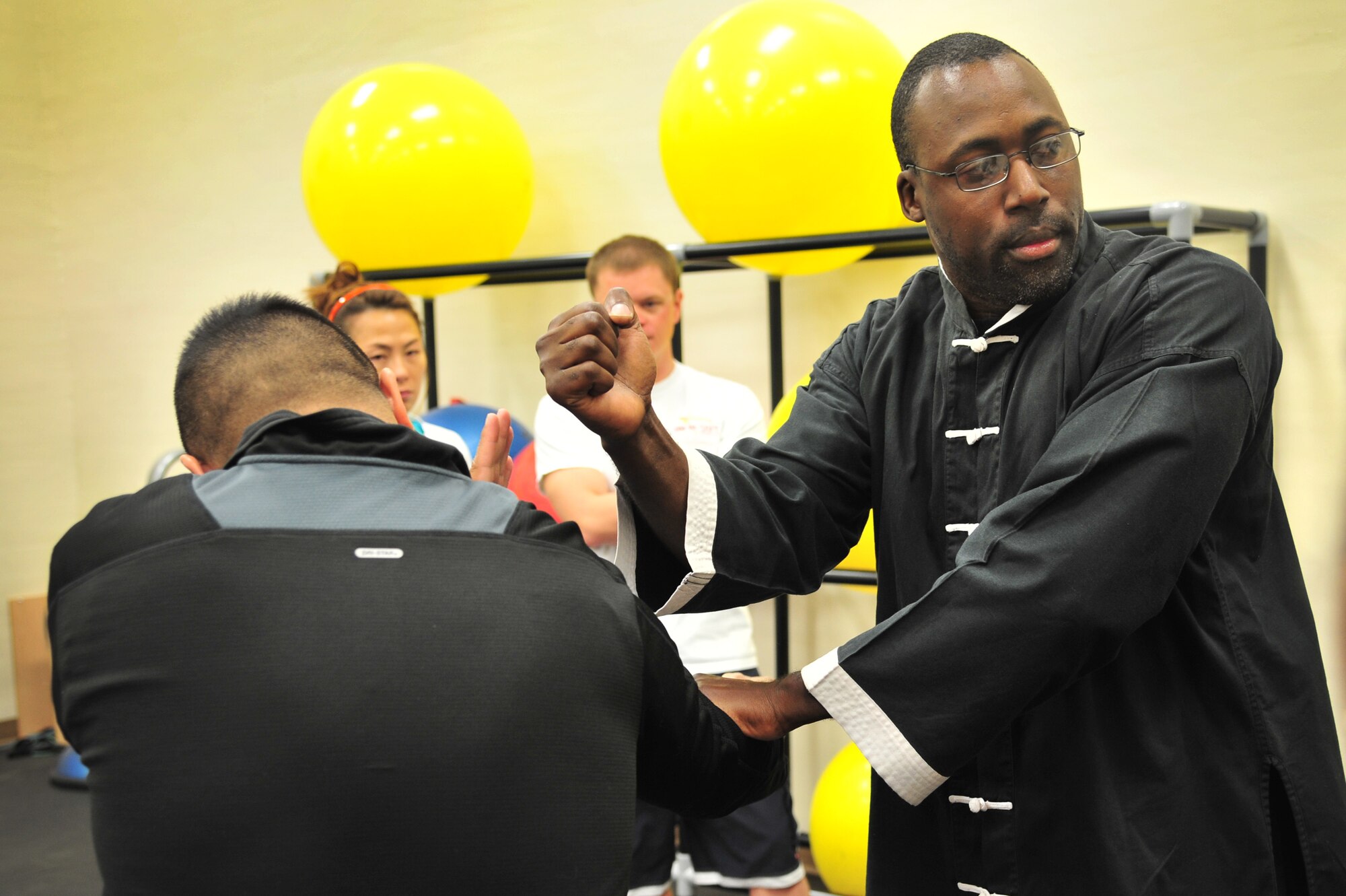 A Jeet Kun Do instructor demonstrates a block, hit combo to students in the Fitness Center at Cannon Air Force Base, N.M., Oct. 20, 2012. The Sexual Assault Response Coordinator office hosted the free self-defense class in conjunction with Domestic Violence Awareness Month. (U.S. Air Force photo/Airman 1st Class Alexxis Pons Abascal)  