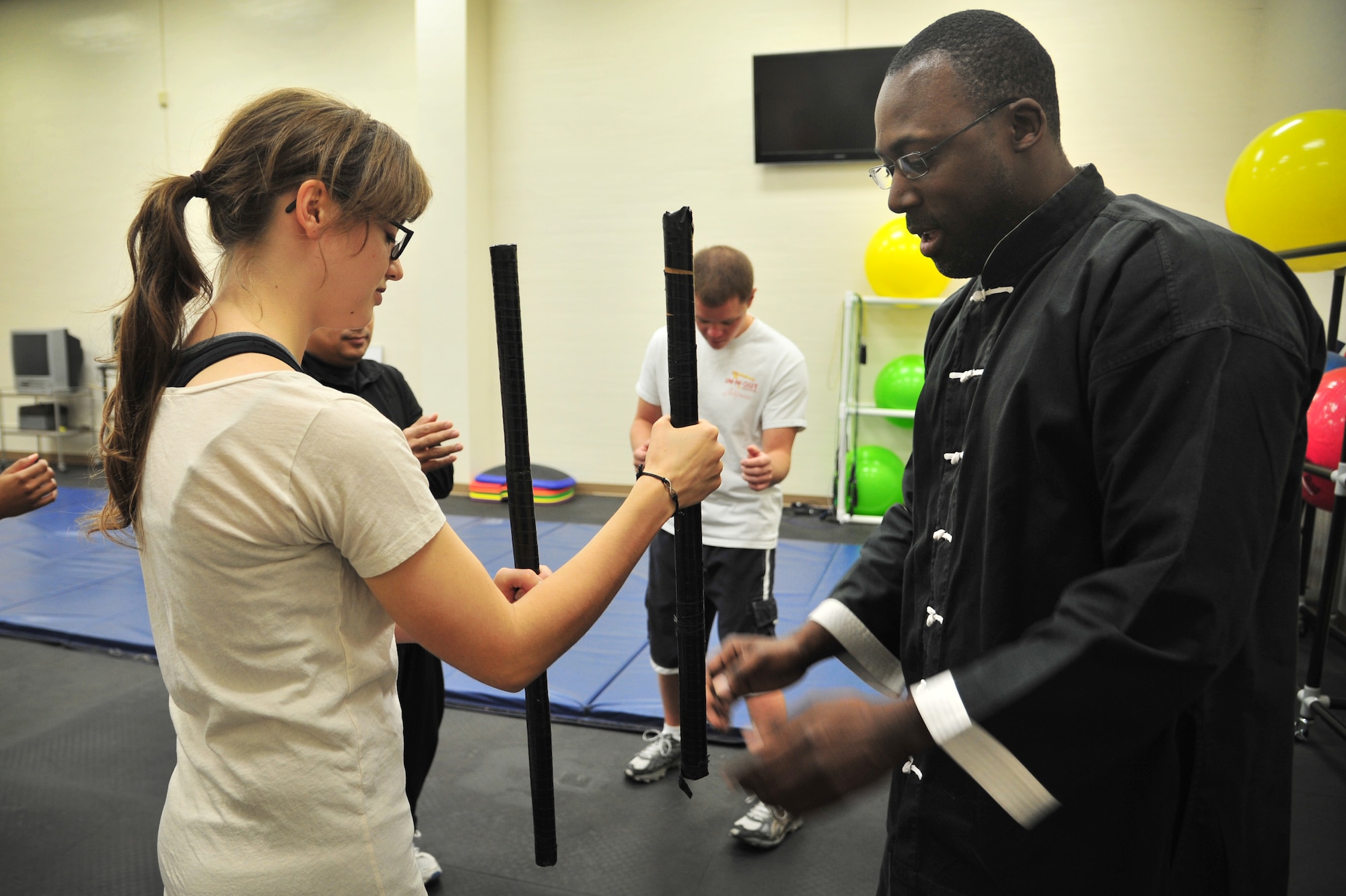 A Jeet Kun Do instructor shows basic fighting stance to a student in the Fitness Center at Cannon Air Force Base, N.M., Oct. 20, 2012. The Sexual Assault Response Coordinator office hosted the free self-defense class in conjunction with Domestic Violence Awareness Month. (U.S. Air Force photo/Airman 1st Class Alexxis Pons Abascal)  