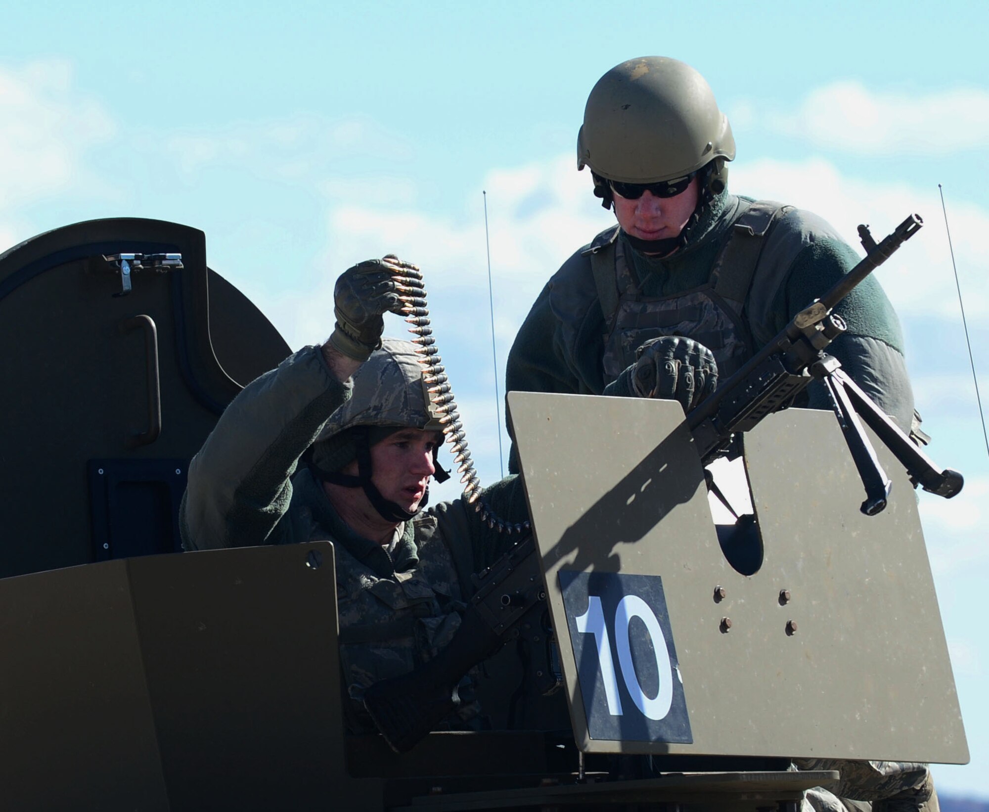 U.S. Air Force Staff Sgt. Jordan Gaddis, 620th Ground Combat Training Squadron combat arms instructor, guides an Airman from F.E Warren Air Force Base, Wyo., before practice firing from a moving vehicle at the North Range of Camp Guernsey, Wyo., Oct. 17, 2012. Airmen from F.E. Warren are participants in a 10-day, annual nuclear-convoy training exercise called Road Warrior. (U.S. Air Force photo by Airman 1st Class Kayla Newman/Released)