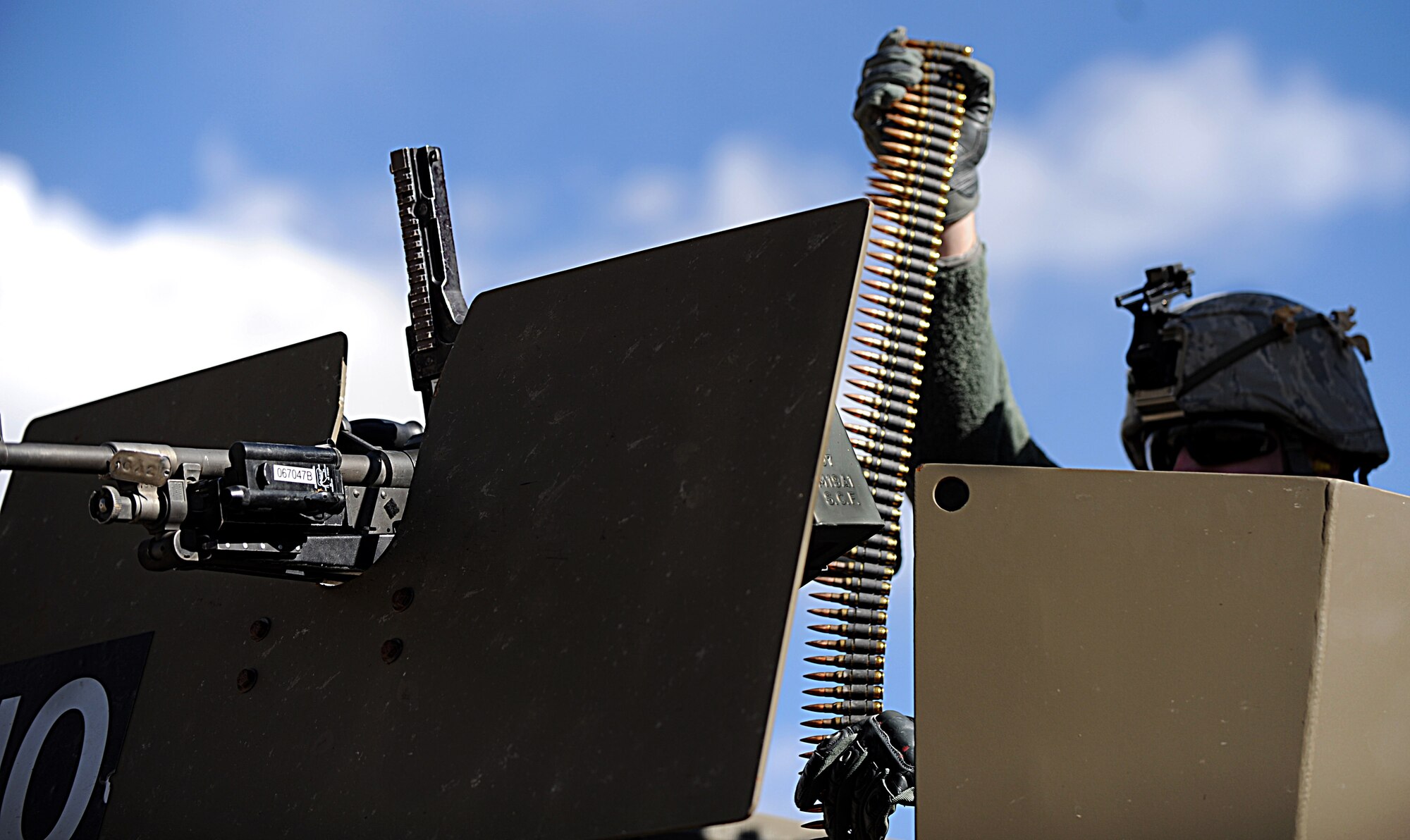 An Airman from F.E. Warren Air Force Base, Wyo. loads rounds into a machine gun, mounted to a vehicle, during a nuclear-convoy training exercise at Camp Guernsey, Wyo., Oct. 17, 2012. The 10-day exercise is designed to teach airmen how to safely transport nuclear resources in a convoy formation. (U.S. Air Force photo by Senior Airman Jarad A. Denton/Released)
