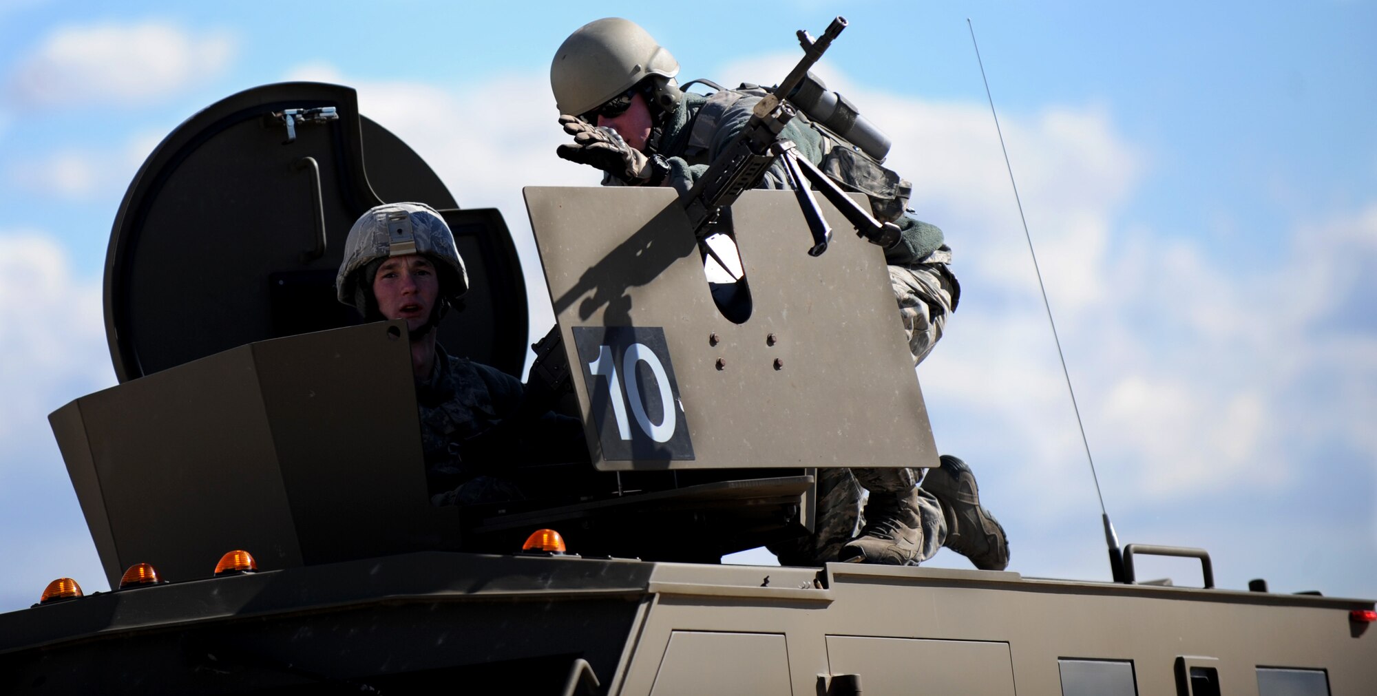 Staff Sgt. Jordan Gaddis (left), 620th Ground Combat Training Squadron combat arms instructor, instructs an Airman from F.E. Warren Air Force Base, Wyo. how to fire from a moving vehicle during a nuclear-convoy training exercise at Camp Guernsey, Wyo., Oct. 17, 2012. The 10-day exercise is designed to teach airmen how to safely transport nuclear resources in a convoy formation. (U.S. Air Force photo by Senior Airman Jarad A. Denton/Released)
