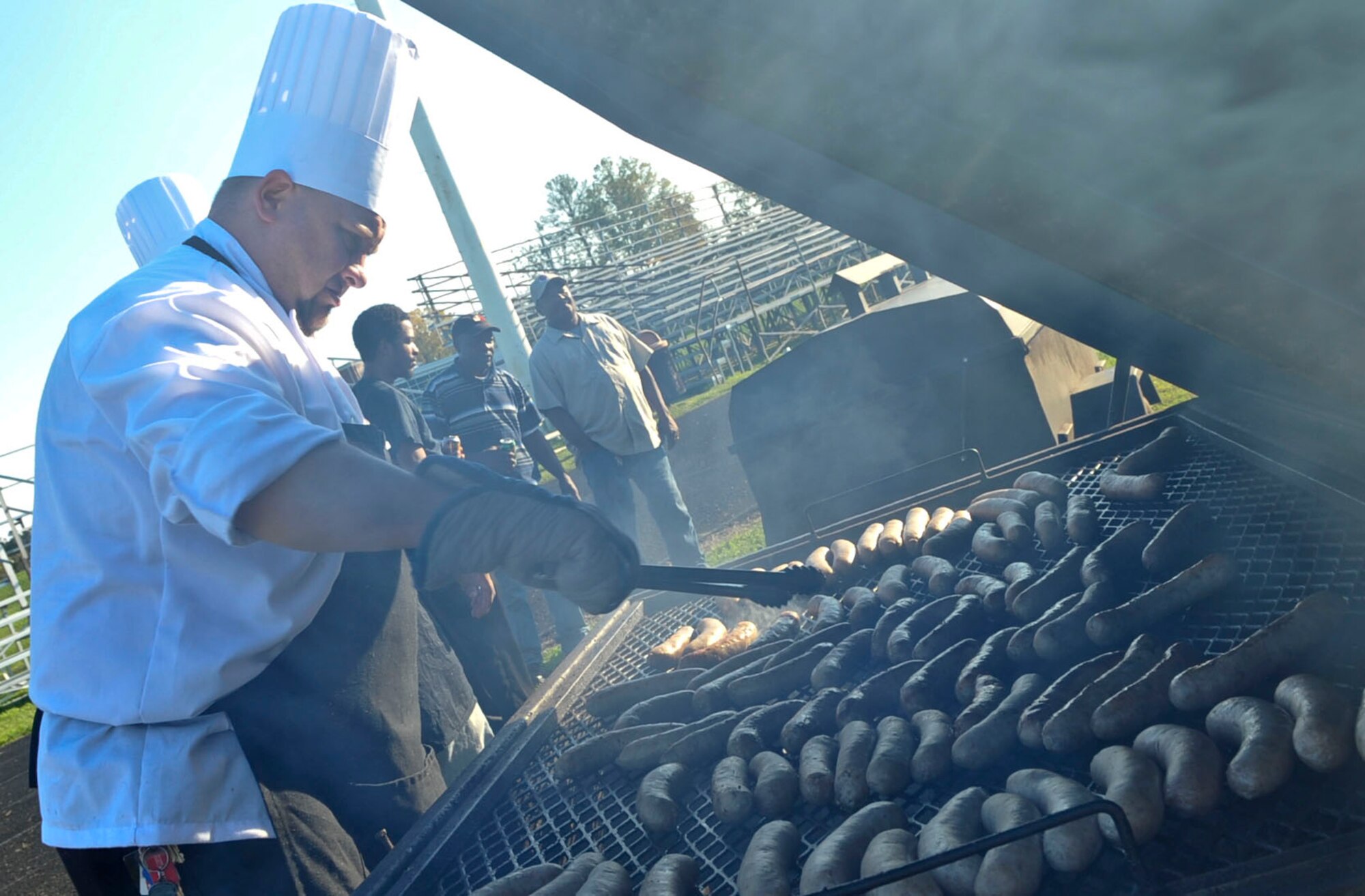 Tim Cooper, Fort Eustis Club executive chef, turns bratwurst on the grill at the first annual Fall Festival held at Fort Eustis, Va., Oct. 19, 2012. The two day event offered a variety of activities the whole family could enjoy. (U.S. Air Force photo by Staff Sgt. Wesley Farnsworth / Released)
