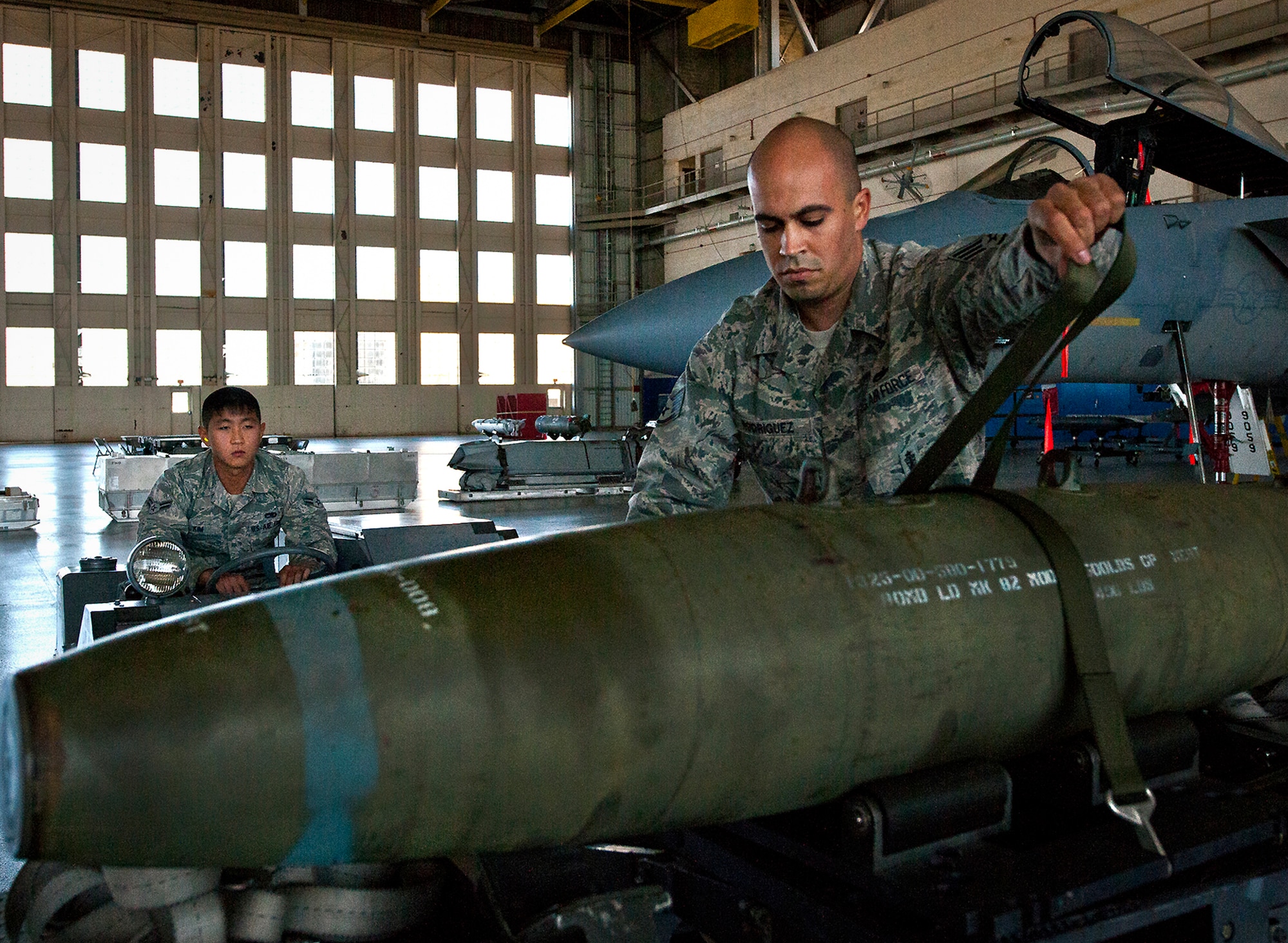 Staff Sgt. Carlos Rodriguez, of the 96th Aircraft Maintenance Squadron, ensures the MK-82 is properly secured before moving it to an F-15 during a weapons load competition Oct. 19 at Eglin Air Force Base, Fla.  Rodriguez and his team won the quarterly competition against an F-16 load crew team.  The competition was measured by how quickly, safely and accurately the teams loaded an MK-82 and an AIM-9M to their respective aircraft.  (U.S. Air Force photo/Samuel King Jr.)