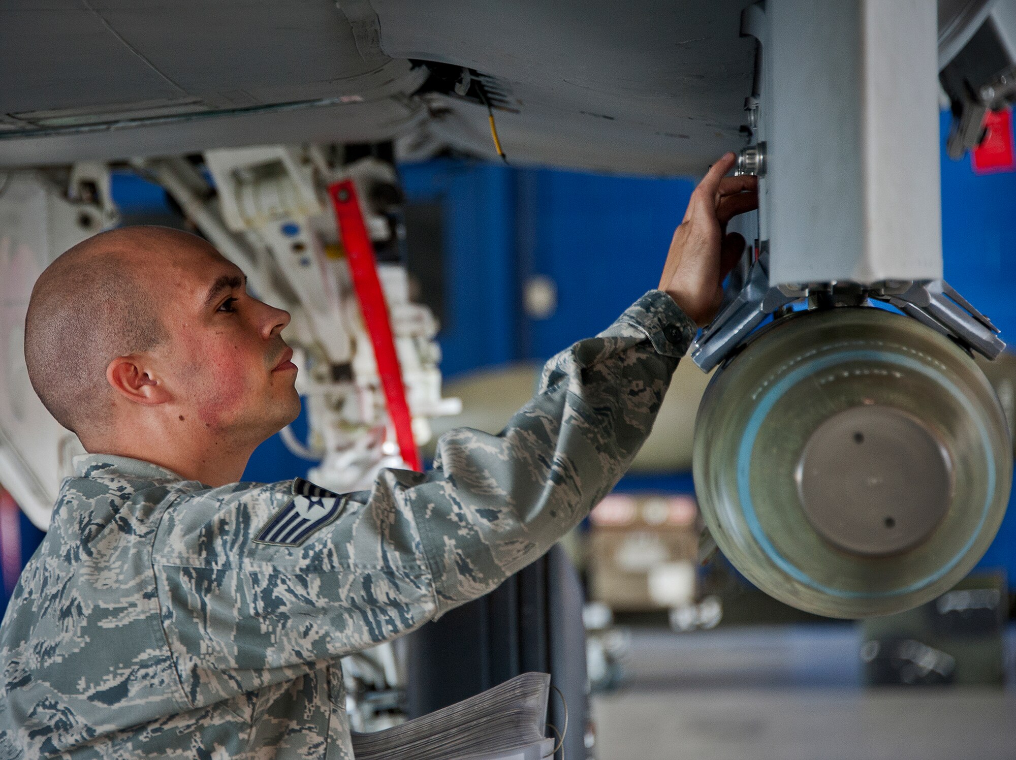 Staff Sgt. Carlos Rodriguez, of the 96th Aircraft Maintenance Squadron, double checks the connection of the MK-82 to an F-15 during a weapons load competition Oct. 19 at Eglin Air Force Base, Fla.  Rodriguez and his team won the quarterly competition against an F-16 load crew team.  The competition was measured by how quickly, safely and accurately the teams loaded an MK-82 and an AIM-9M to their respective aircraft.  (U.S. Air Force photo/Samuel King Jr.)