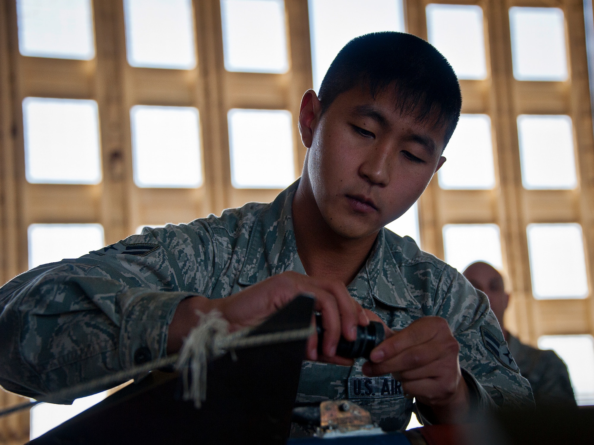 Senior Airman Andrew Kim, of the 96th Aircraft Maintenance Squadron, prepares an AIM-9M to be moved to an F-15 during a weapons load competition Oct. 19 at Eglin Air Force Base, Fla.  Kim and his team won the quarterly competition against an F-16 load crew team.  The competition was measured by how quickly, safely and accurately the teams loaded an MK-82 and an AIM-9M to their respective aircraft.  (U.S. Air Force photo/Samuel King Jr.)