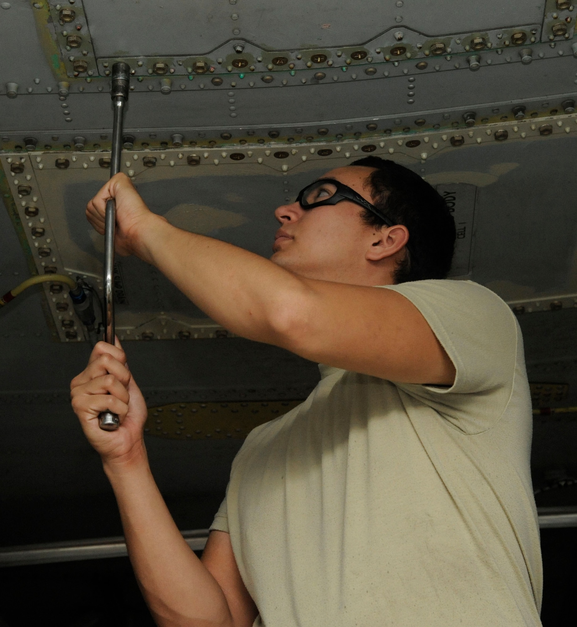 Airman 1st Class Scott Hooper, 2nd Maintenance Squadron Accessories Flight fuels maintenance section, removes the mid-body section panel to gain access to a fuel tank of a B-52H Stratofortress on Barksdale Air Force Base, La., Oct. 16. Airmen in the fuels section have the responsibility of diagnosing and repairing the various fuel systems and fuel tanks on the B-52 to ensure the aircraft completes its mission of delivering precision munitions on the battlefield. (U.S. Air Force photo/Airman 1st Class Andrew Moua)(RELEASED)