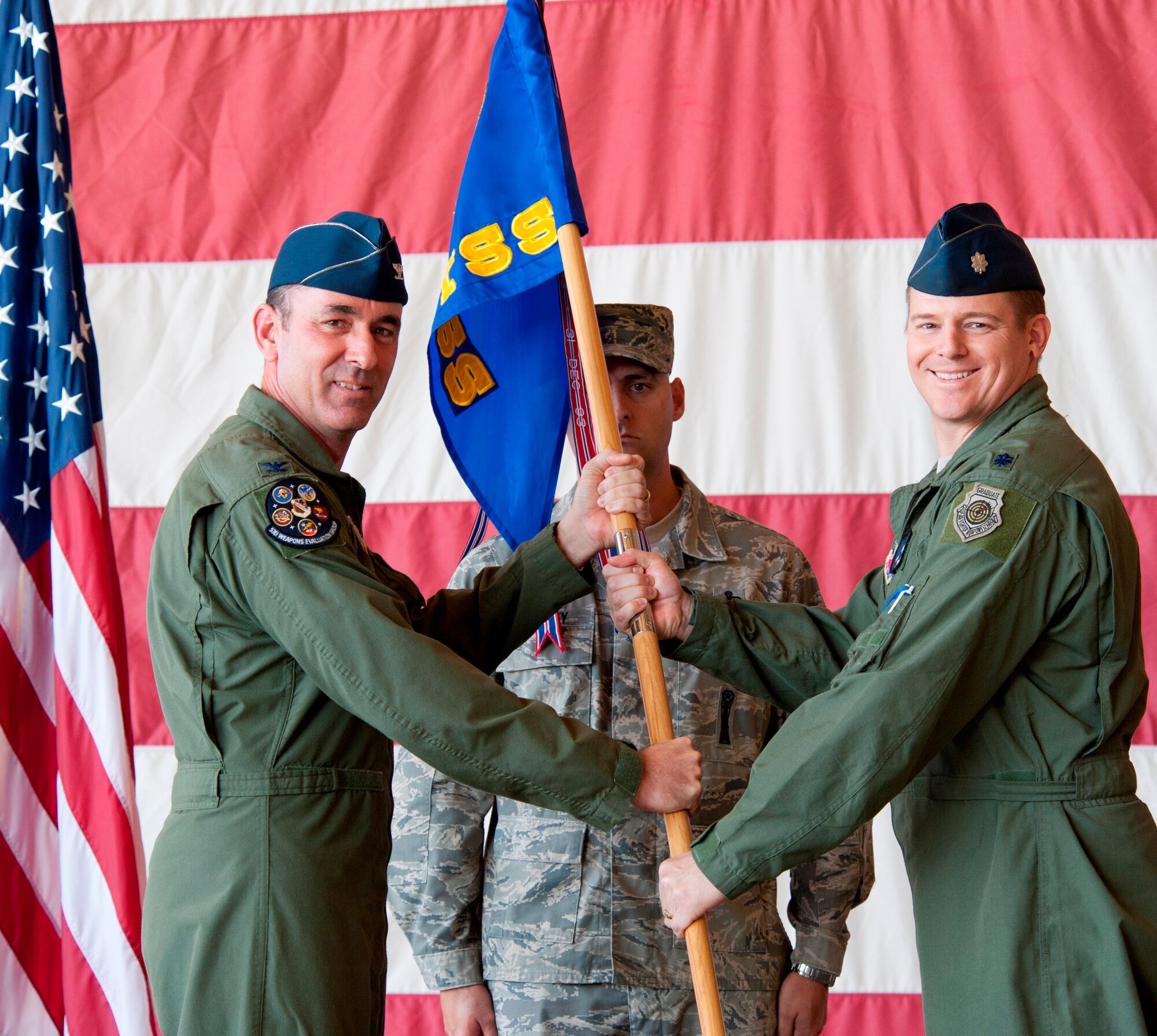 Colonel James Vogel (Left), 53rd Weapons Evaluation Group commander, passes the 53rd Test Support Squadron guidon to Lt. Col. Joseph Kendall (Right) who assumed command of the 53rd TSS in a change of command ceremony, Oct. 19. (U.S. Air Force photo by Lisa Norman) 