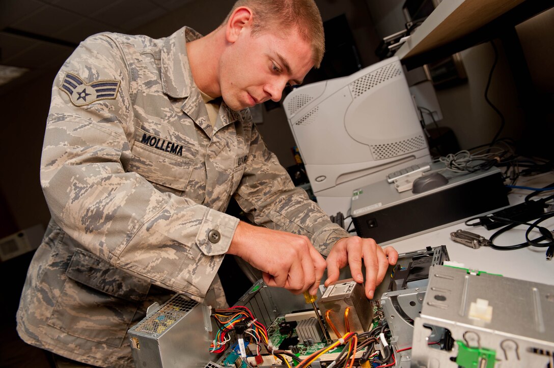 Senior Airman Travis Mollema, 28th Communications Squadron client system technician, repairs and troubleshoots a computer during maintenance at Ellsworth Air Force Base, S.D., Oct. 16, 2012. Ellsworth saves an estimated $18,000 annually by having specialists repair computers instead of purchasing new machines. (U.S. Air Force photo by Airman 1st Class Zachary Hada/Released)