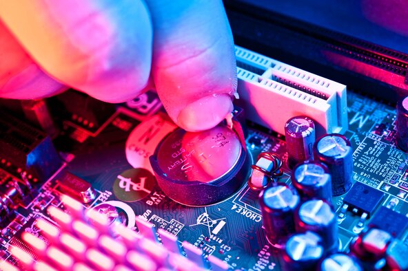 Senior Airman Travis Mollema, 28th Communications Squadron client system technician, replaces a faulty metal-oxide semi-conductor battery on a computer motherboard during maintenance at Ellsworth Air Force Base, S.D., Oct. 16, 2012. The CMOS battery is responsible for powering the computer’s memory and real time clock while computer systems are on or off. A faulty battery can lead to loss of time, date, and basic input and output system settings. (U.S. Air Force photo by Airman 1st Class Zachary Hada/Released)
