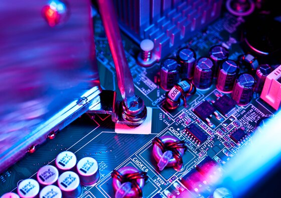 Senior Airman Travis Mollema, 28th Communications Squadron client system technician, loosens a screw to replace a faulty heat sink unit in a computer during repairs at Ellsworth Air Force Base, S.D., Oct. 16, 2012. Heat sink units cool devices by dissipating surrounding heat to prevent electronic systems from overheating and failing. (U.S. Air Force photo by Airman 1st Class Zachary Hada/Released)