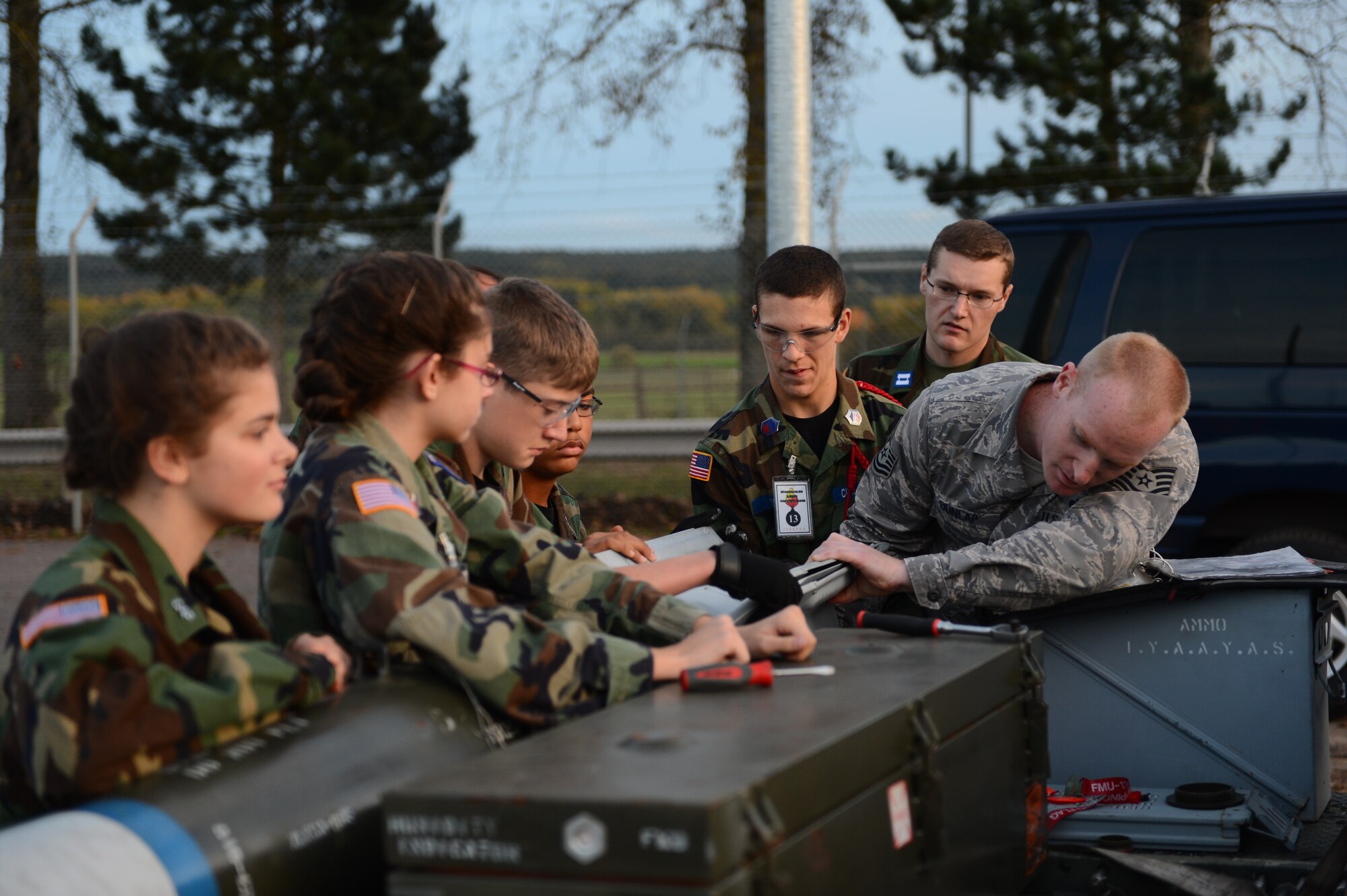 SPANGDAHLEM AIR BASE, Germany – U.S. Air Force Tech. Sgt. Kyle Dunlap, right, 52nd Equipment Maintenance Squadron conventional maintenance productions supervisor from Sierra Vista, Ariz., helps cadets from the Spangdahlem Civil Air Patrol attach a tail fin on an inert Mark 82 bomb during their tour of a conventional maintenance shop Oct. 19, 2012. The cadets got the chance to assemble a laser-targeting system, inert fuse and tail fins on an inert bomb. (U.S. Air Force photo by Airman 1st Class Dillon Davis/Released)