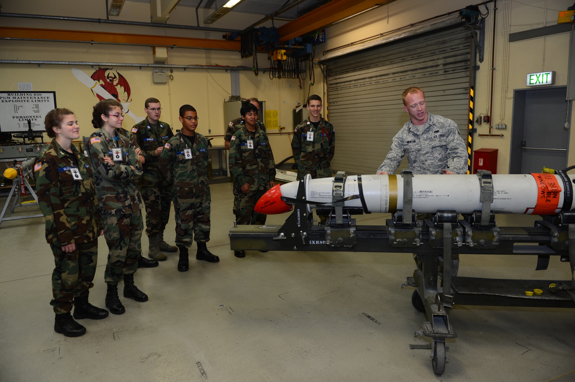 SPANGDAHLEM AIR BASE, Germany – U.S. Air Force Senior Airman Jacob Newton, right, 52nd Equipment Maintenance Squadron technician from Sherwood, Ore., shows cadets from the Spangdahlem Civil Air Patrol the capabilities of a radar guided missile during a tour of a missile maintenance shop Oct. 19, 2012. The cadets were able to see various missiles up close while learning about the maintenance and uses of them. (U.S. Air Force photo by Airman 1st Class Dillon Davis/Released)