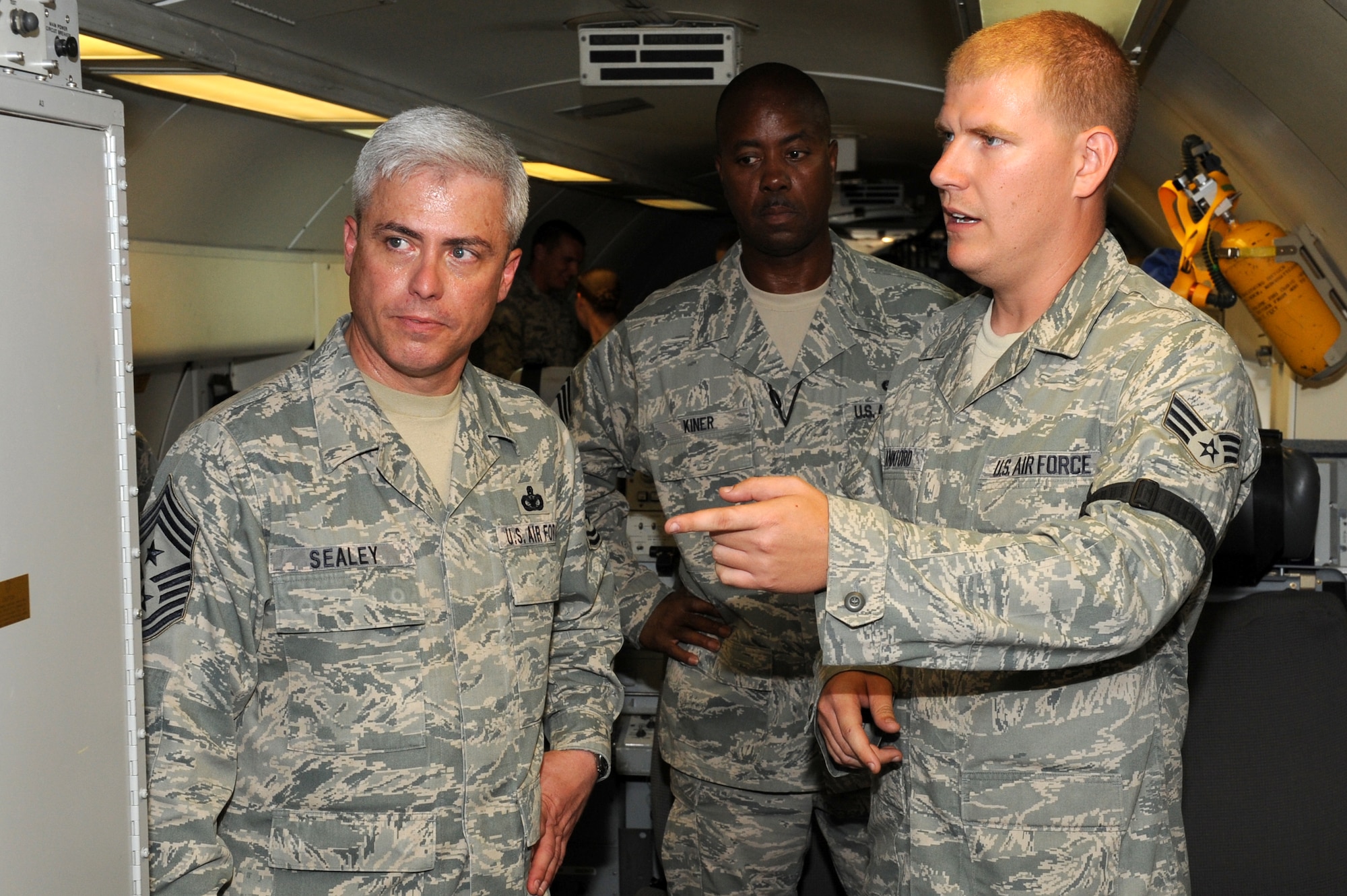 SOUTHWEST ASIA - U.S. Air Force Chief Master Sgt. Robert Sealey, U.S. Air Forces Central Command command chief, speaks with Senior Airman Jonathan Lankford  aboard an E-3 Sentry as Chief Master Sgt. Kevin Kiner, 970th Expeditionary Airborne Air Control Squadron superintendent, looks on Oct. 17, 2012. Sealey visited with 380th AEW Airmen to reinforce a force protection mindset and continued excellence in all areas. (U.S. Air Force photo/Master Sgt. Scott MacKay)