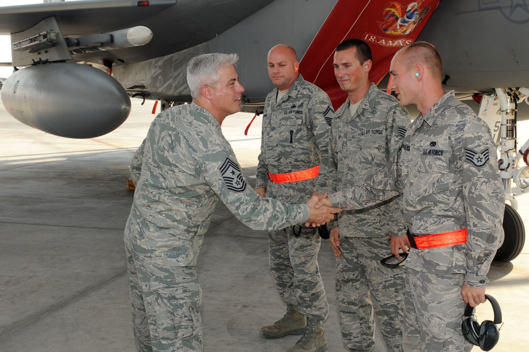 SOUTHWEST ASIA - U.S. Air Force Chief Master Sgt. Robert Sealey, U.S. Air Forces Central Command command chief, shakes hands with maintainers from the 380th Expeditionary Aircraft Maintenance Squadron Oct. 17, 2012. Sealey visited with 380th AEW Airmen to reinforce a force protection mindset and continued excellence in all areas. (U.S. Air Force photo/Master Sgt. Scott MacKay)