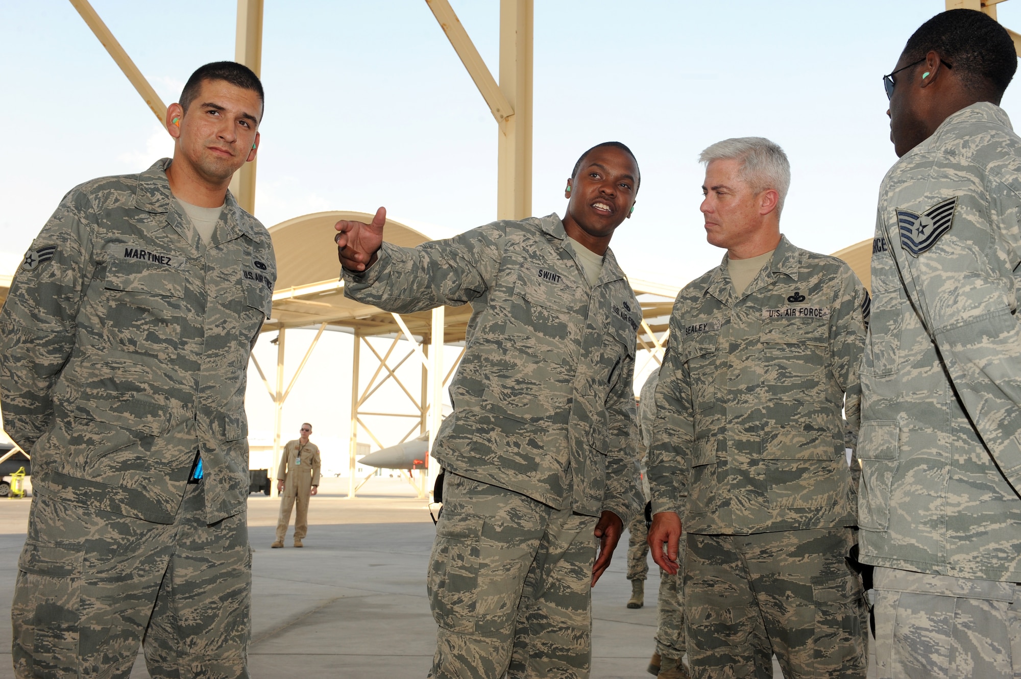 SOUTHWEST ASIA - U.S. Air Force Chief Master Sgt. Robert Sealey, U.S. Air Forces Central Command command chief, talks aircraft maintenance with Staff Sgt. John Swint, 380th Expeditionary Aircraft Maintenance Squadron, Oct. 17, 2012. Sealey toured the flightline and visited several units across the wing during his visit. (U.S. Air Force photo/Master Sgt. Scott MacKay)
