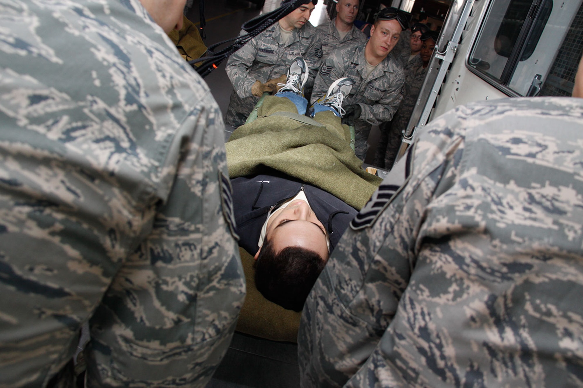 Airmen from the 911th Aeromedical Staging Squadron load a patient onto a bus during a mass casualty exercise on base, Oct. 14, 2012. The training provided by the Aeromedical Evacuation Squadron, included Self-Aid Buddy Care, litter carries and proper procedures of transportation. These two squadrons work hand-in-hand when dealing with casualties in a combat environment providing ground medical assistance and in-flight medical support. (U.S. Air Force photo by Senior Airman Justyne Obeldobel/Released)
