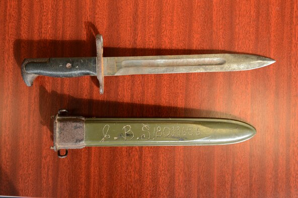 A bayonet and sheath belonging to U.S. Army Pfc. Clyde Sparks lay on a table at the 606th Air Control Squadron Oct. 4, 2012. Sparks lost the bayonet in Luxembourg in 1944, and after 68 years the bayonet was returned to his family. (U.S. Air Force photo by Staff Sgt. Nathanael Callon)