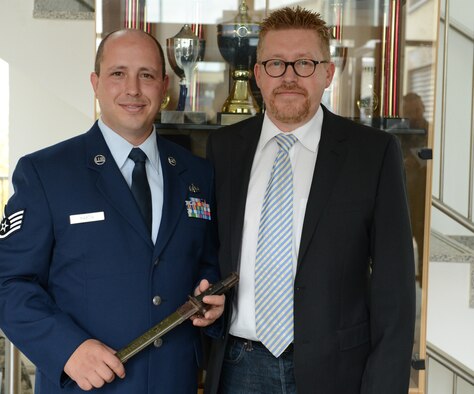 U.S. Air Force Staff Sgt. Scott Martin, 606th Air Control Squadron radio frequencies transmissions systems operator from Chico, Calif., and Marco Haas, from Boulaide, Luxembourg, share a moment together at the 606th ACS headquarters Oct. 4, 2012. Haas’ father, Alphonse Haas, found the bayonet in his parents’ home after U.S. troops used the house as an aid station in 1944. The bayonet was a Haas family heirloom until Marco began looking for the rightful owner of the weapon in 2001. (U.S. Air Force photo by Staff Sgt. Nathanael Callon)